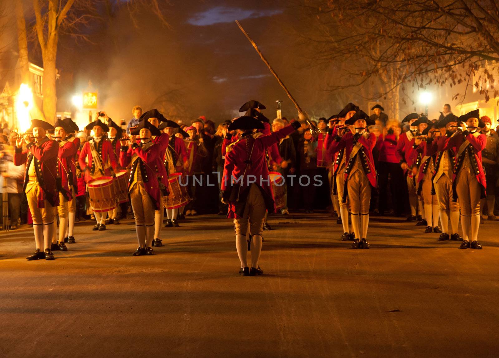 WILLIAMSBURG, VIRGINIA - DECEMBER 29: Marching soldiers at night on December 29, 2011. Colonial Williamsburg's 301 acres includes many restored buildings and houses and hosts re-enactments.