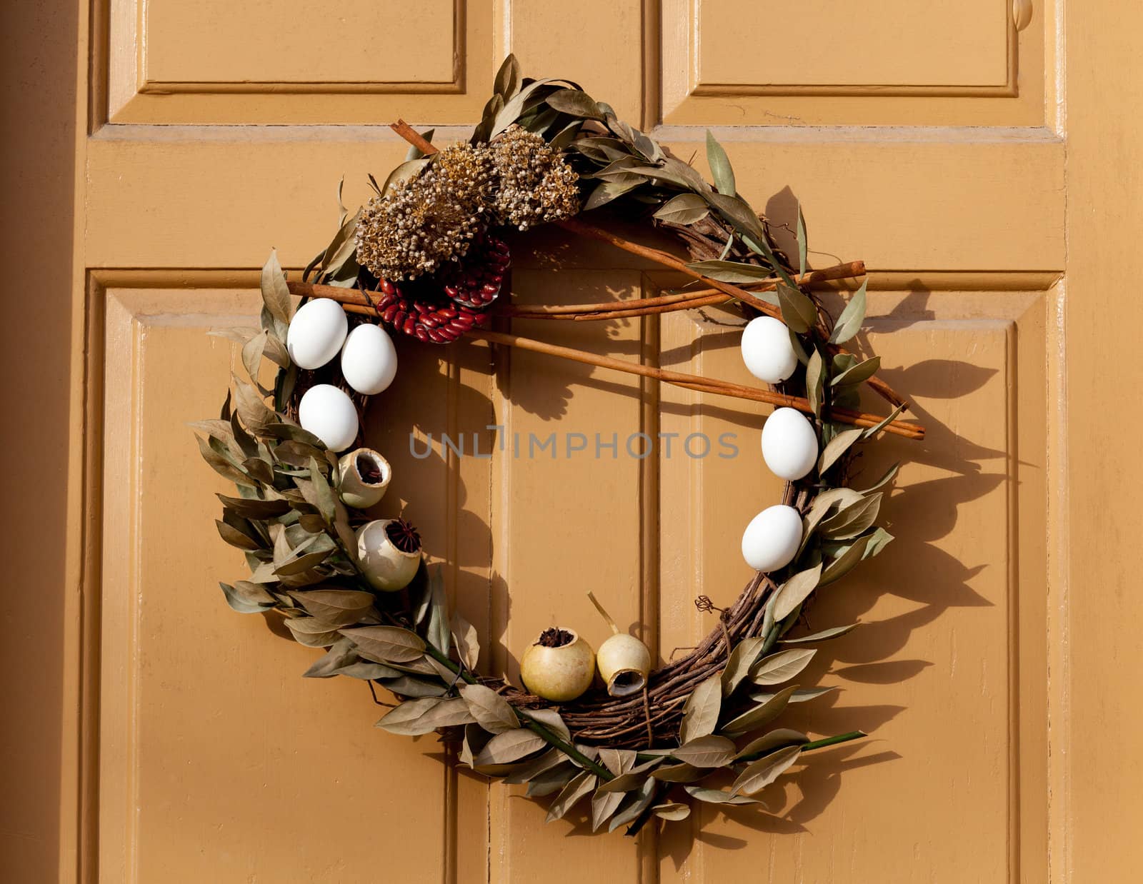 Traditional design of a christmas wreath attached to the front door of old house