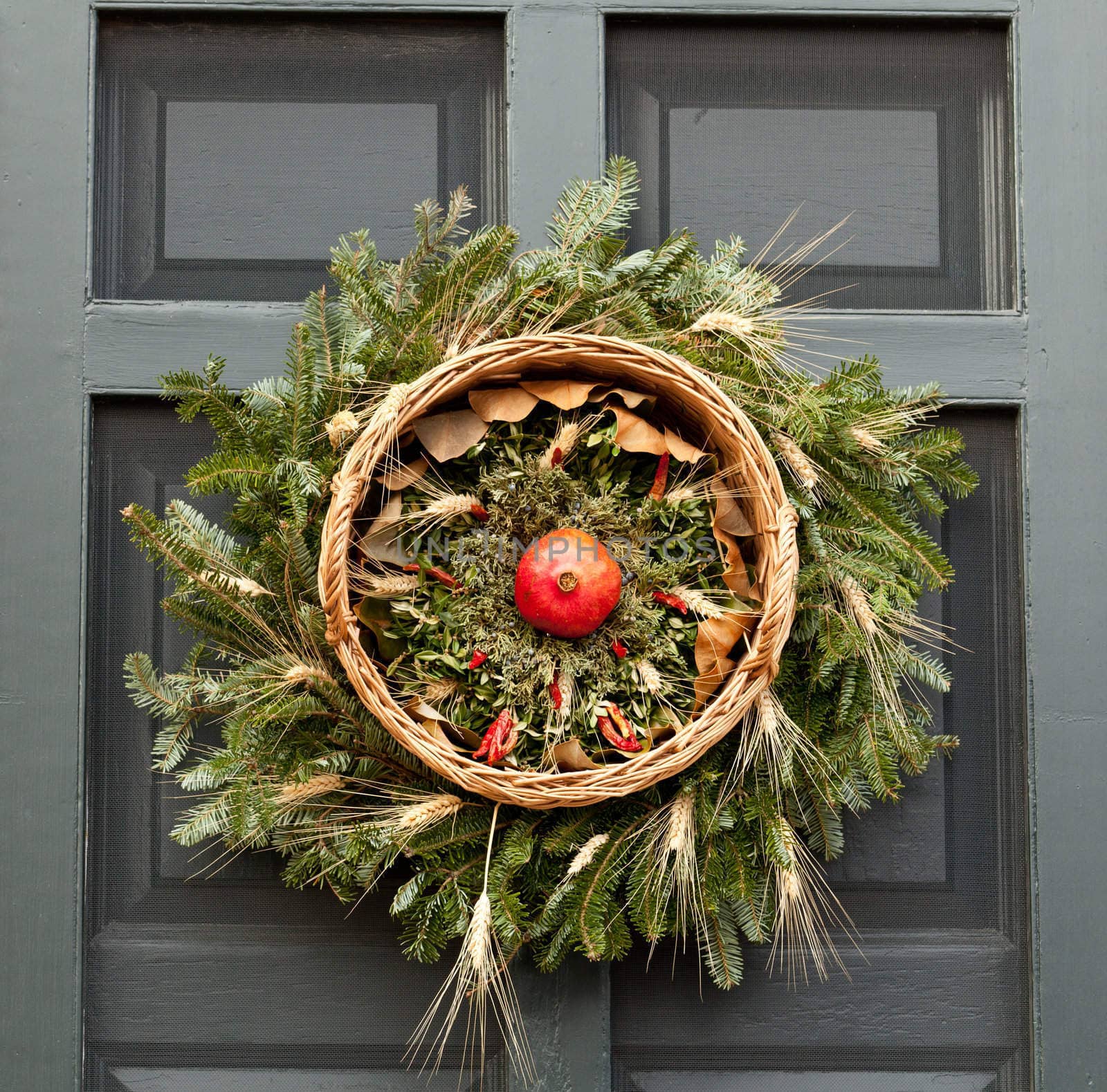 Traditional design of a christmas wreath attached to the front door of old house