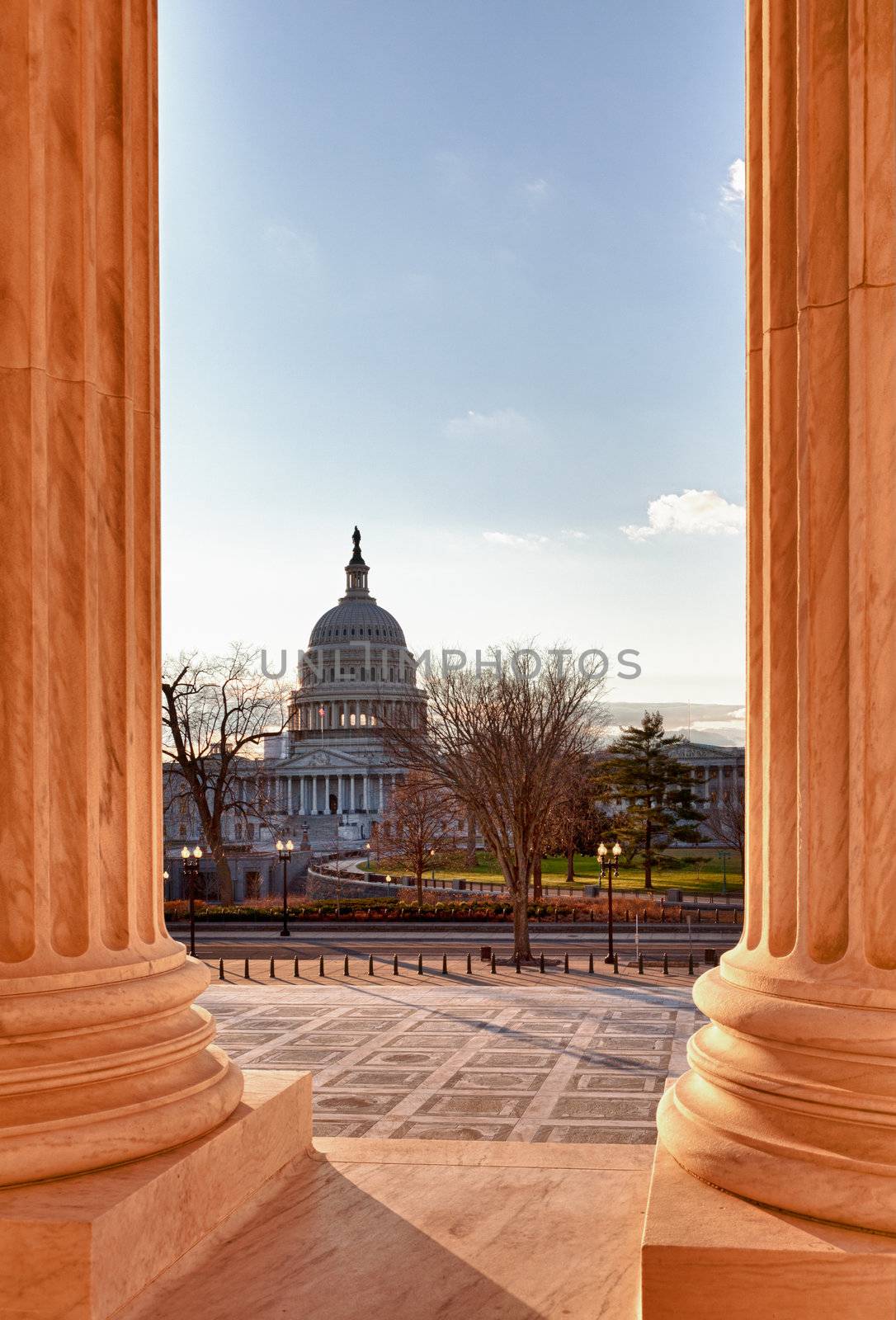 Late afternoon winter sun illuminates front of supreme court in Washington in winter with view of Capitol