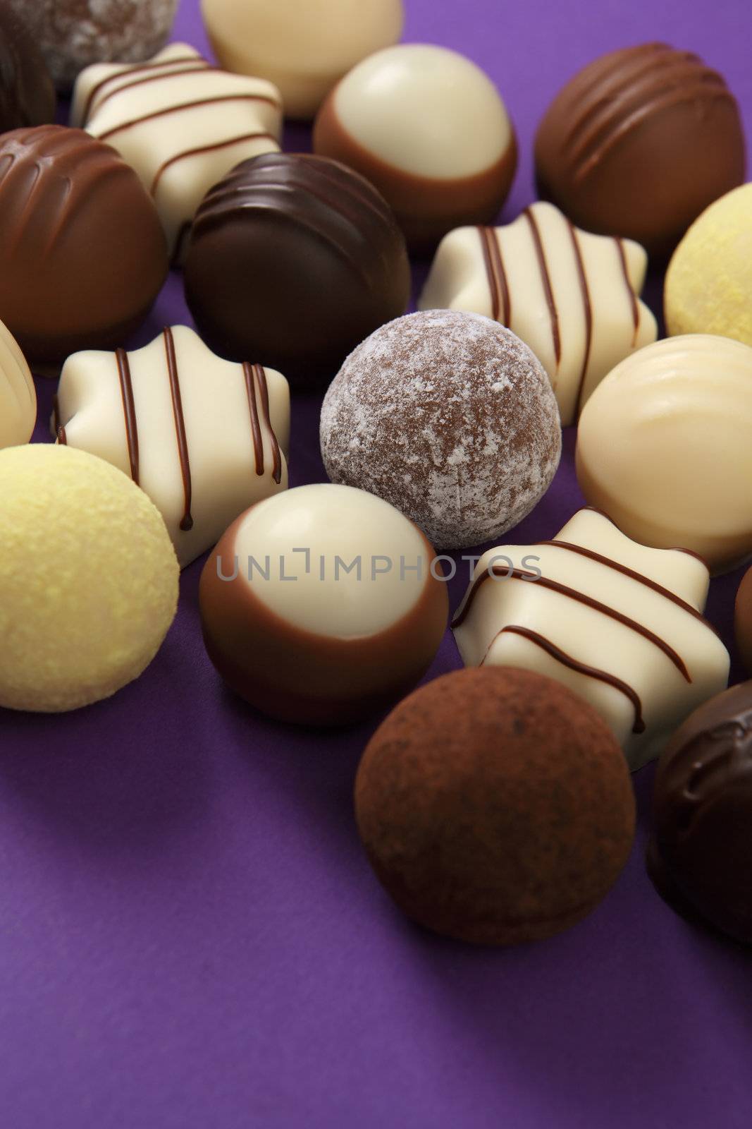 Chocolates and truffles on purple by sumners