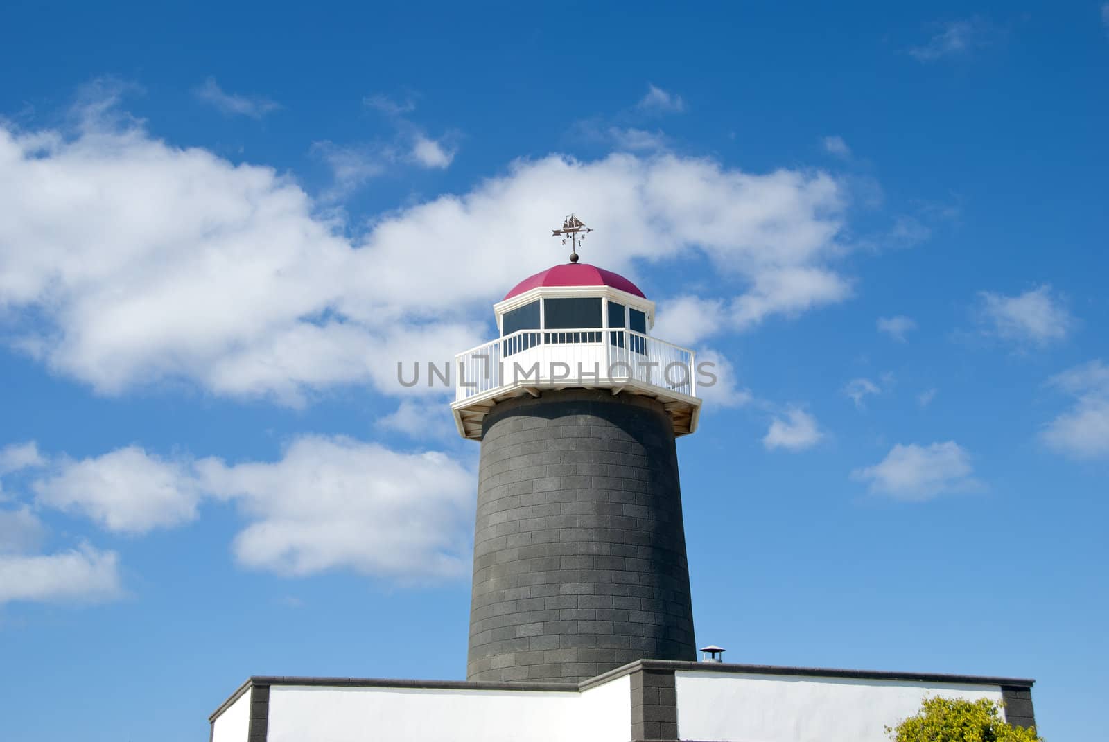 An Old Lighthouse in the Canary Islands with a sailing ship Weathervane