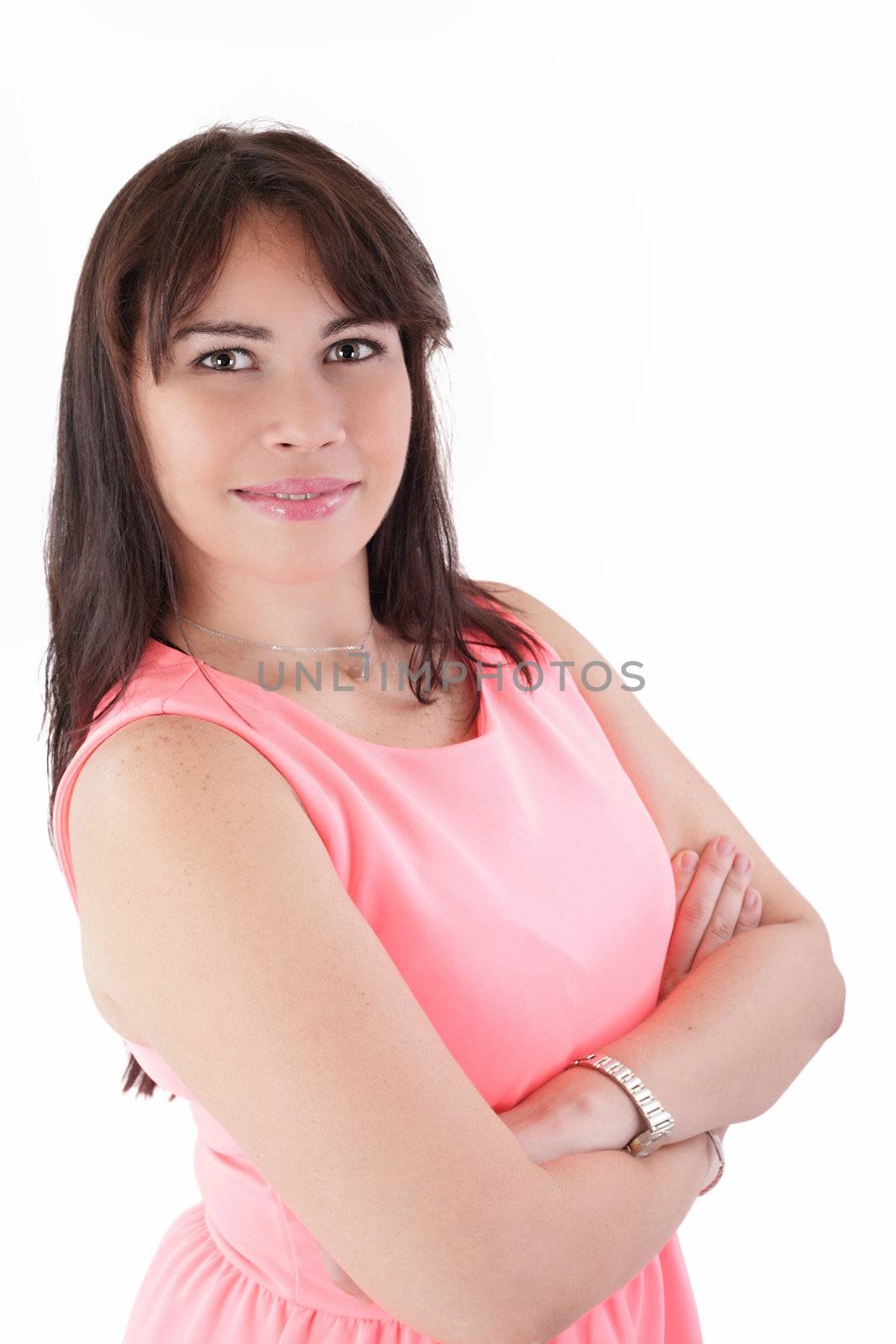 Portrait of a happy young business woman standing with folded hand against white background