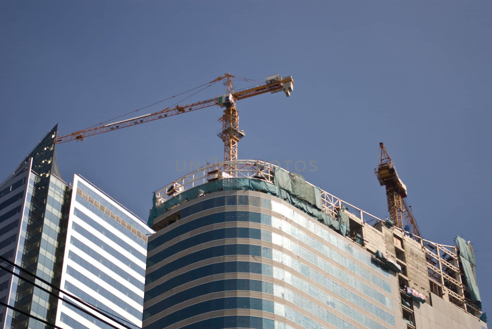 Crane on the top of Building for build the tower