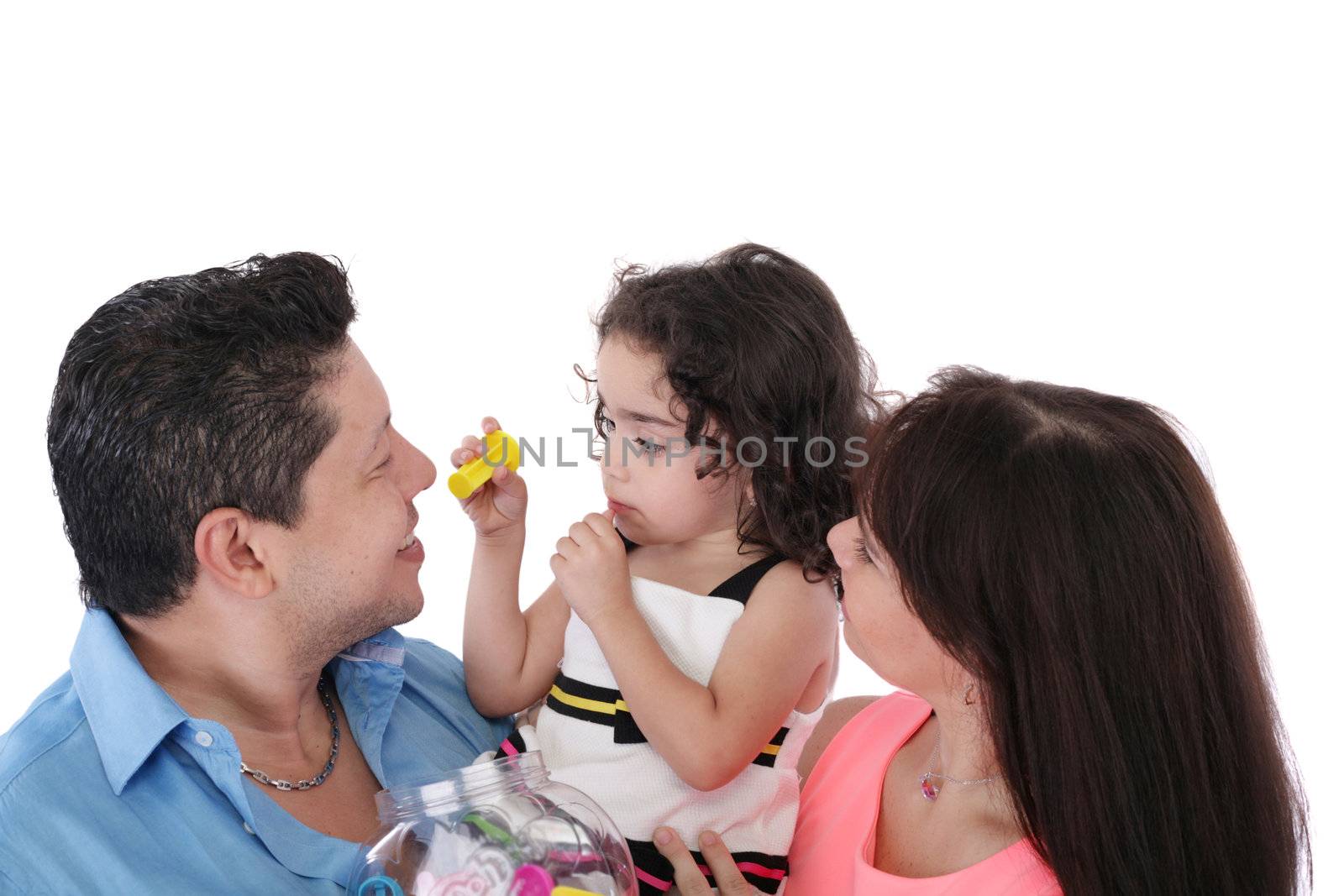 Dad, wife and daughter in the studio on a white background. Focus in the little girl.