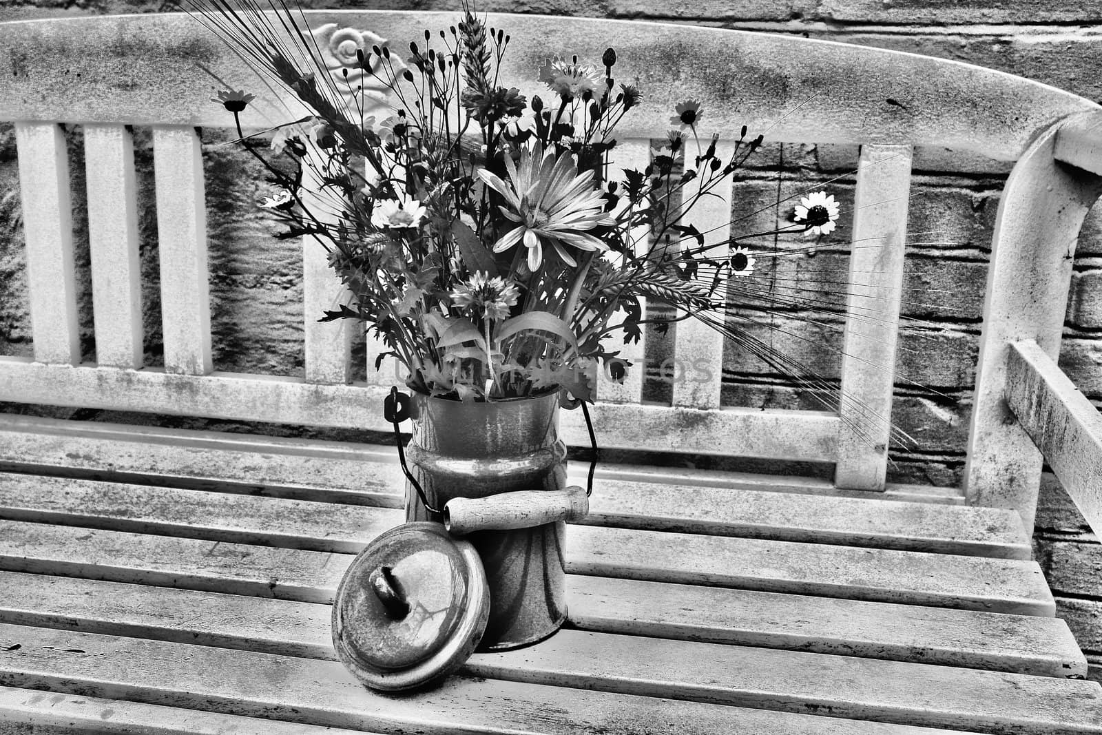 Beautiful spring summer flowers in a blue tin bucket on a garden bench digital art manipulation