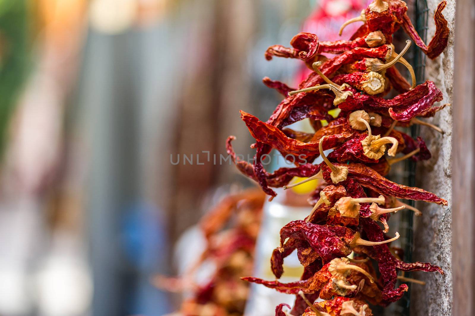 Dried Red Hot Chili Peppers hanging from the wall of old building in Antalya, Turkey. Very small depth of field, copy space