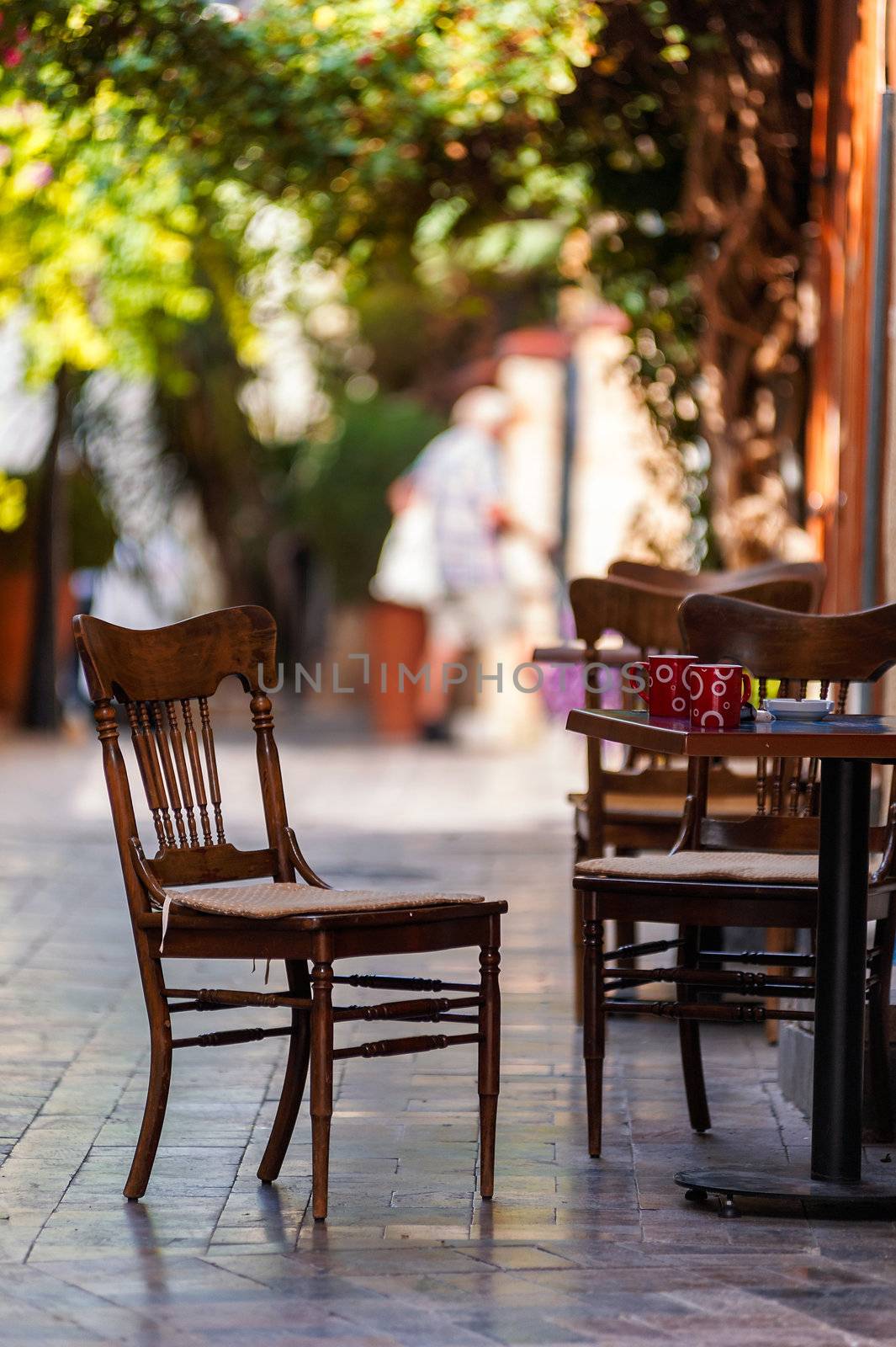Street view of a empty coffee terrace with tables and chairs in old town of Antalya, Turkey. Small depth of field.