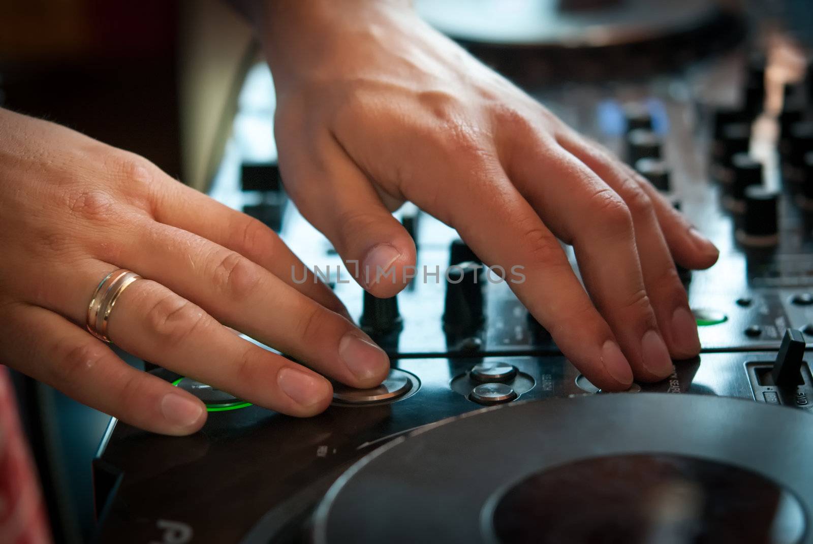 DJ playng on professional mixing controller. Small depth of field