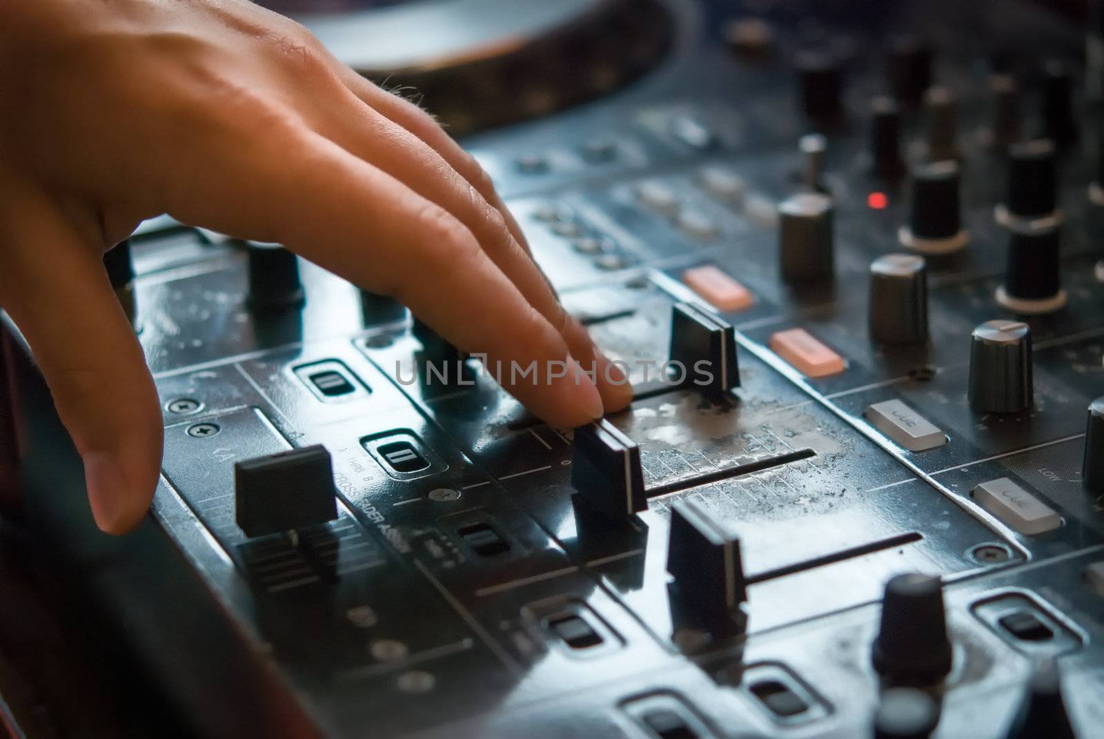 DJ playng on professional mixing controller. Small depth of field