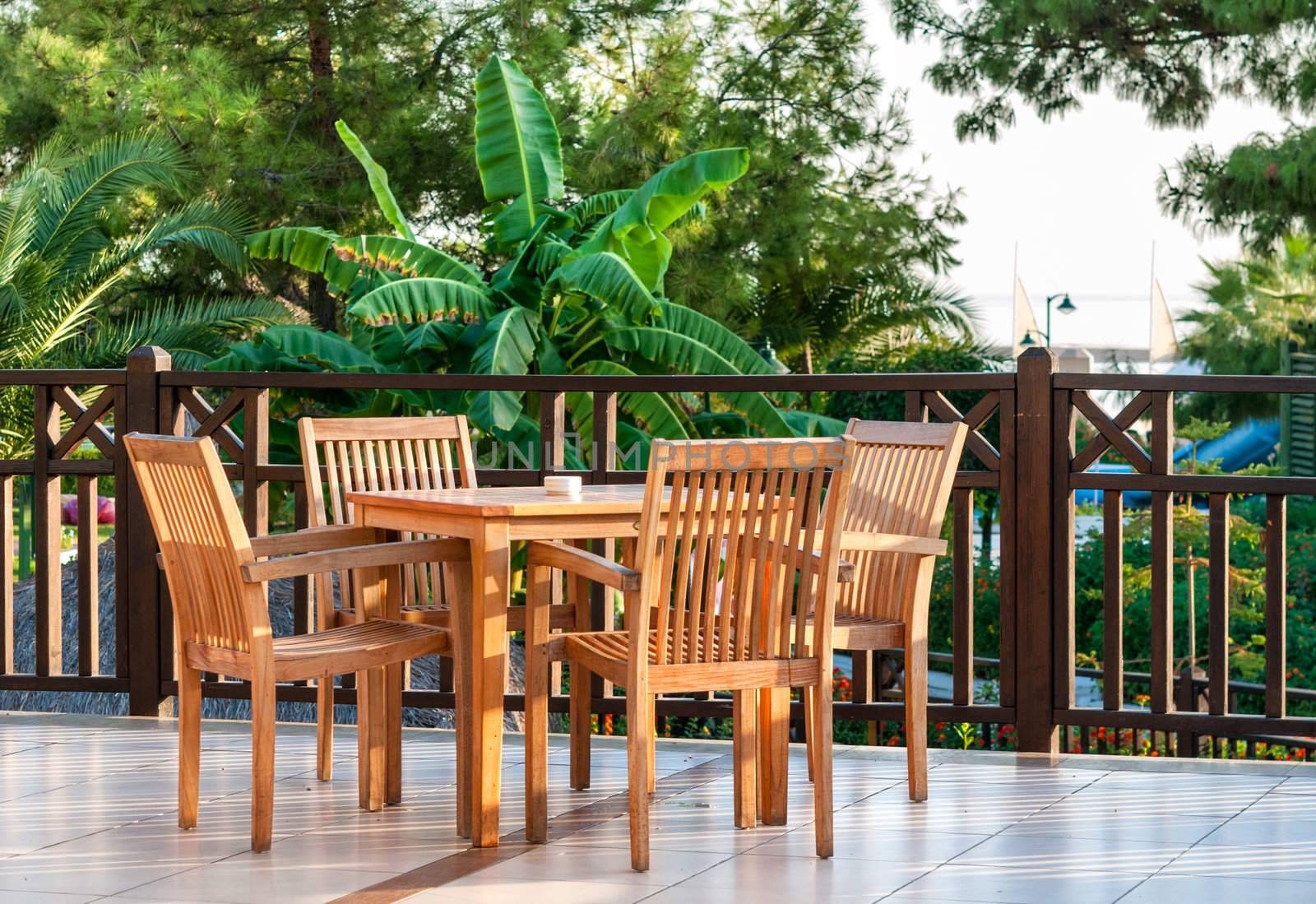 Table setting on a terraced lounge at a mediterranean resort hotel overlooking the sea