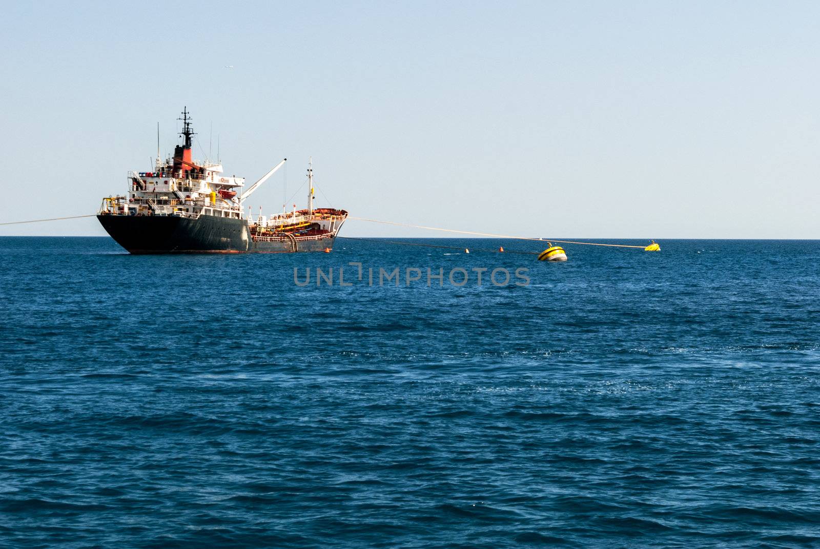 Cargo ship at sea by kirs-ua