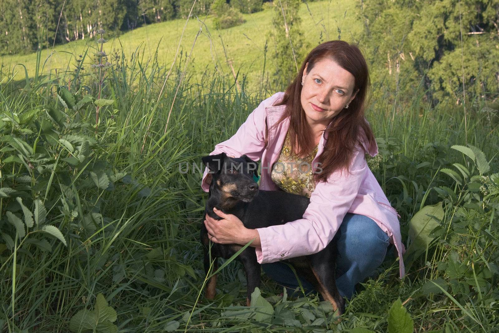 The woman with a dog on a marge of a wood