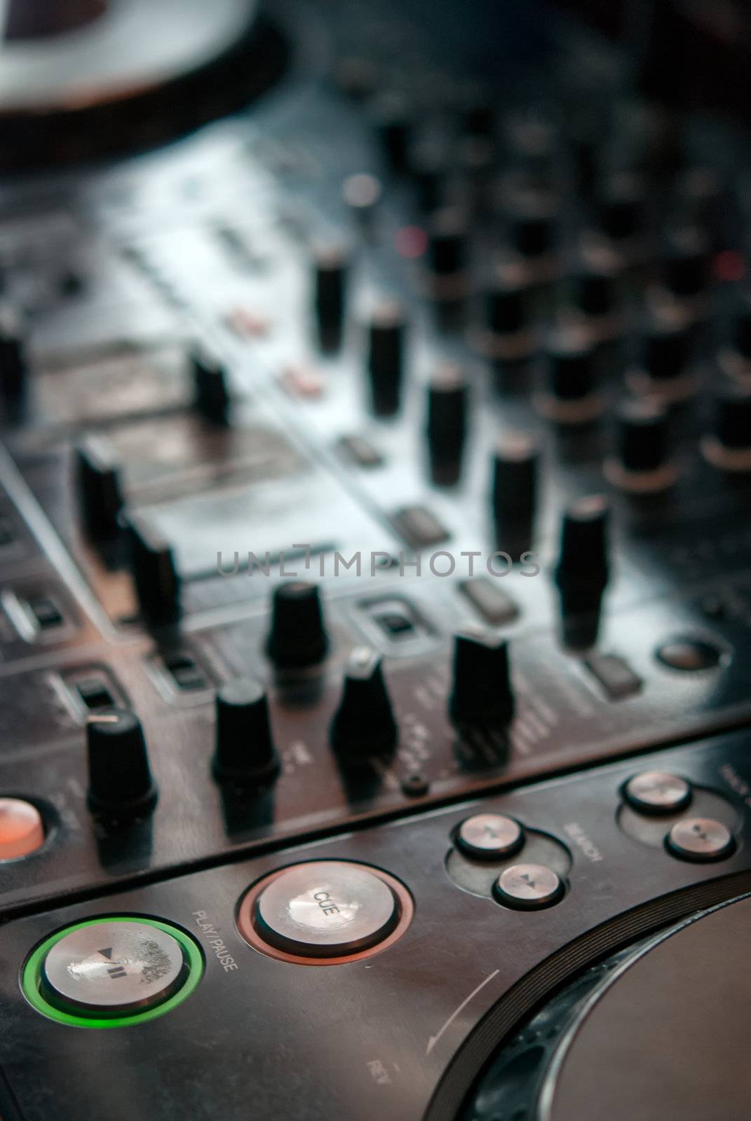 DJ playng on professional mixing controller. Small depth of field