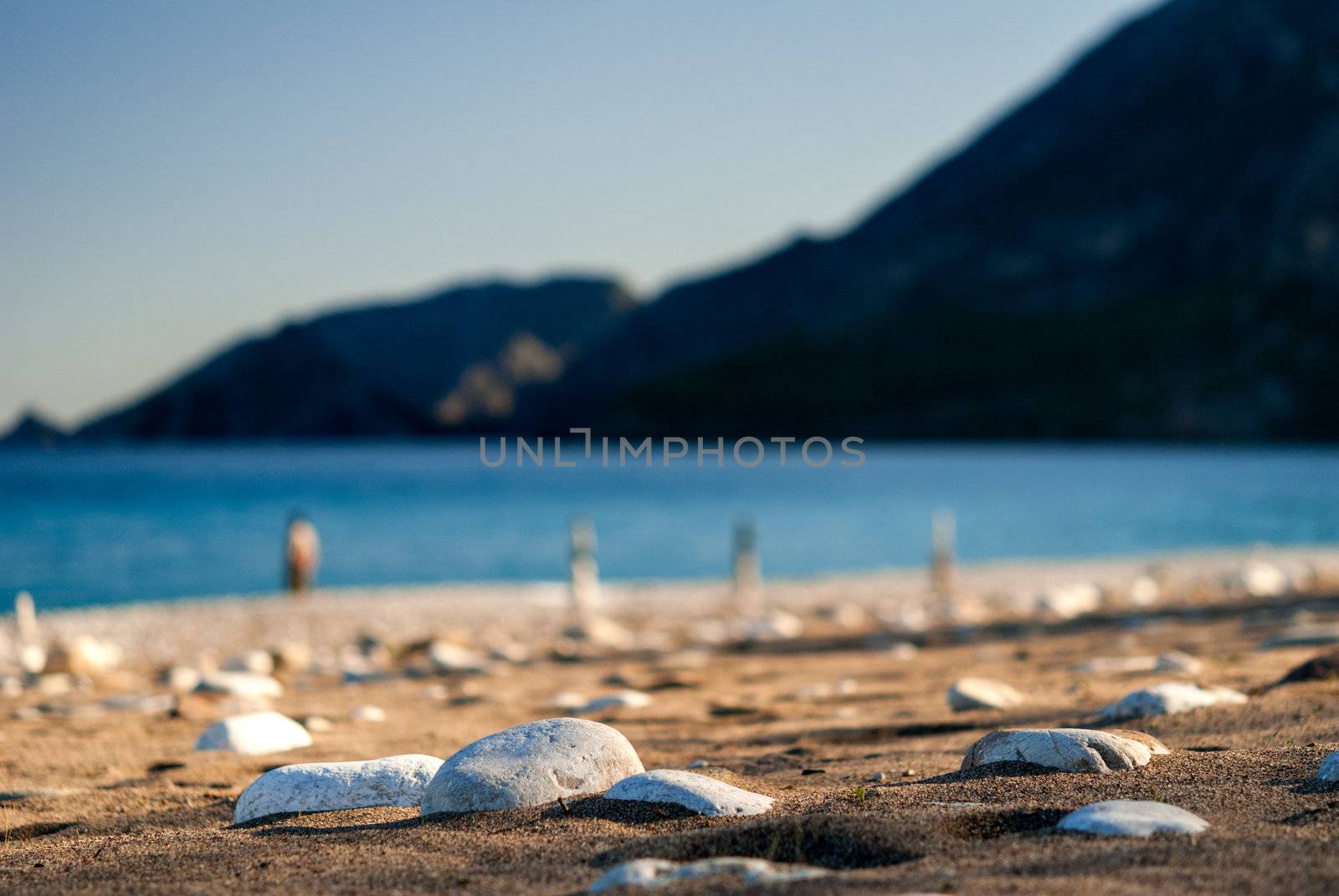 Stones on the sand beach close-up by kirs-ua