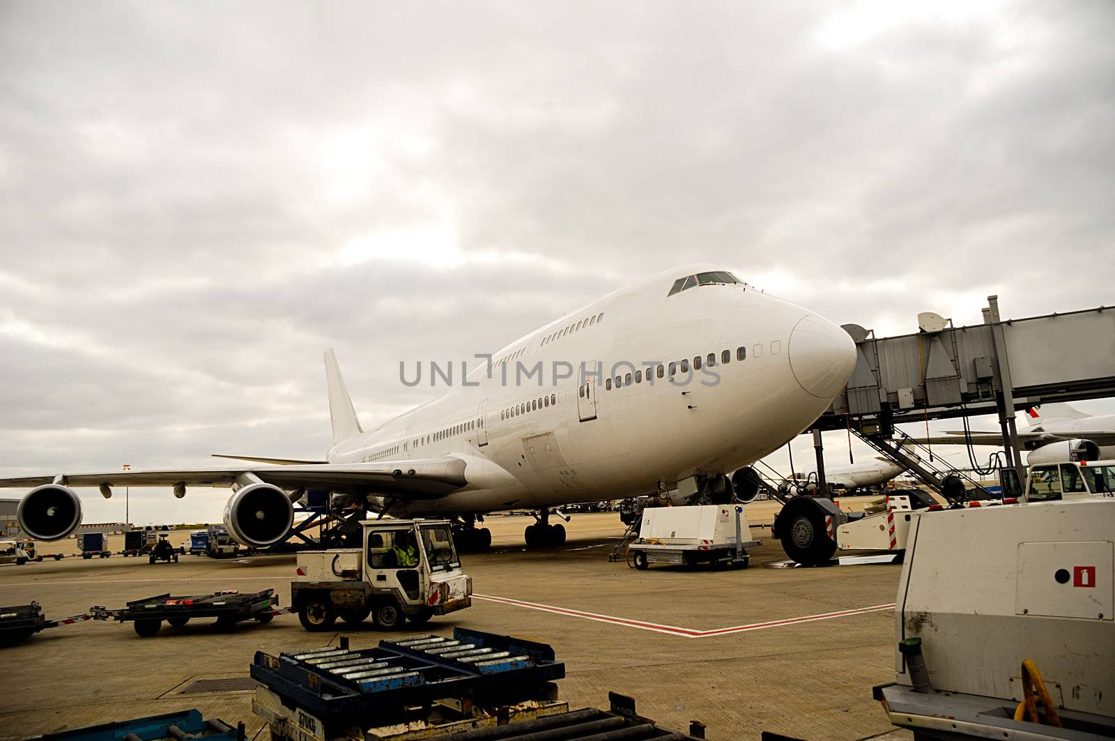 Air travel - A parked plane is loading off Passengers in an airport