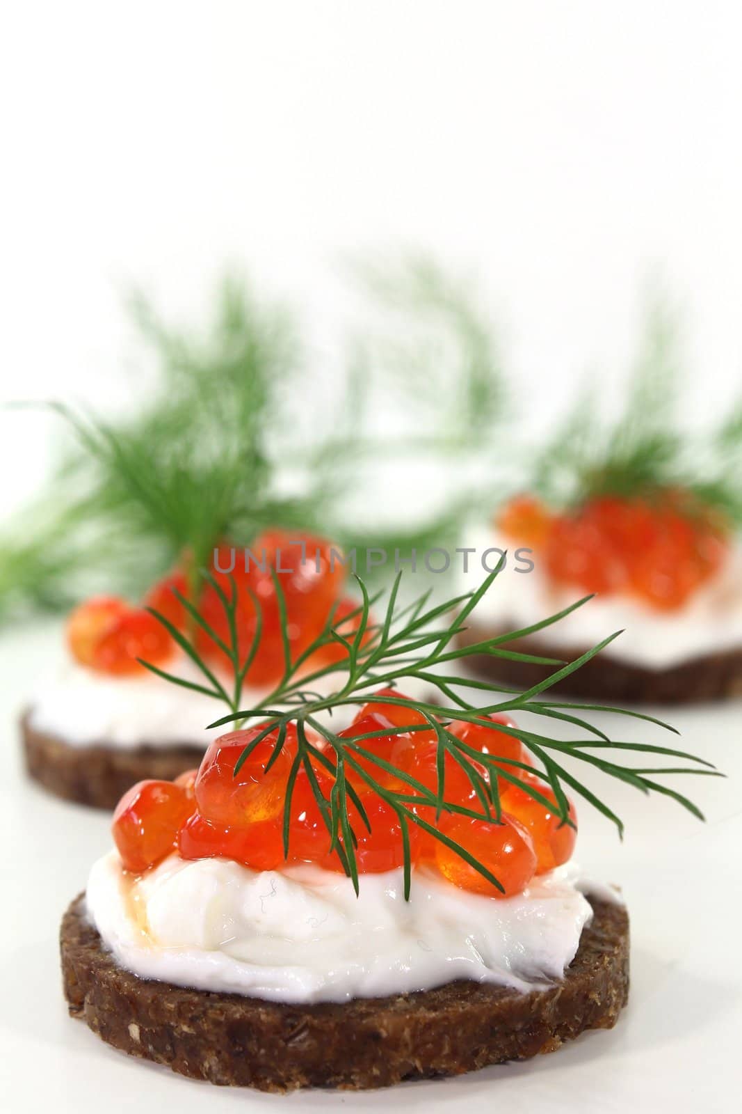 Pumpernickel with dill and caviar on a white background