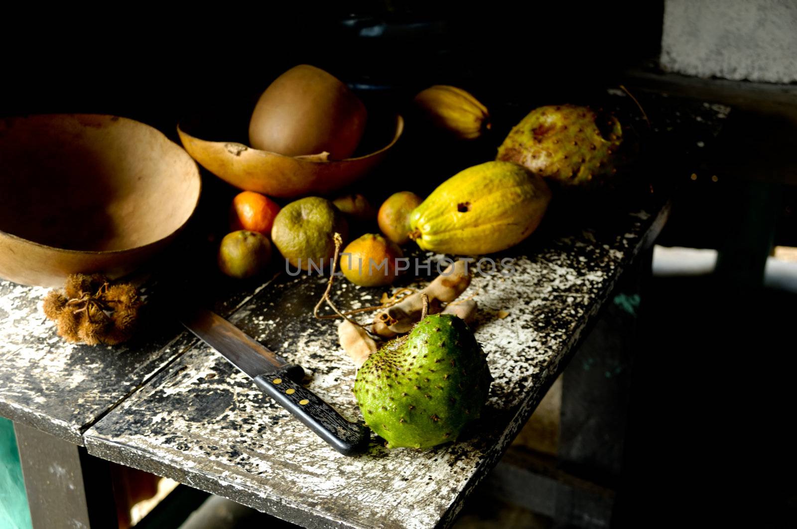 Old kitchen table with fruit  by cfoto