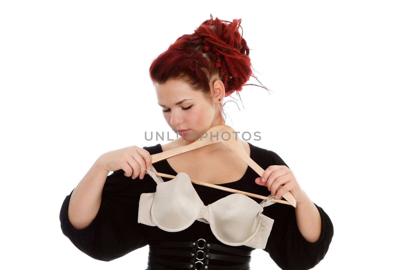 Young modern girl with red hair isolated on a white background, wearing bra.
