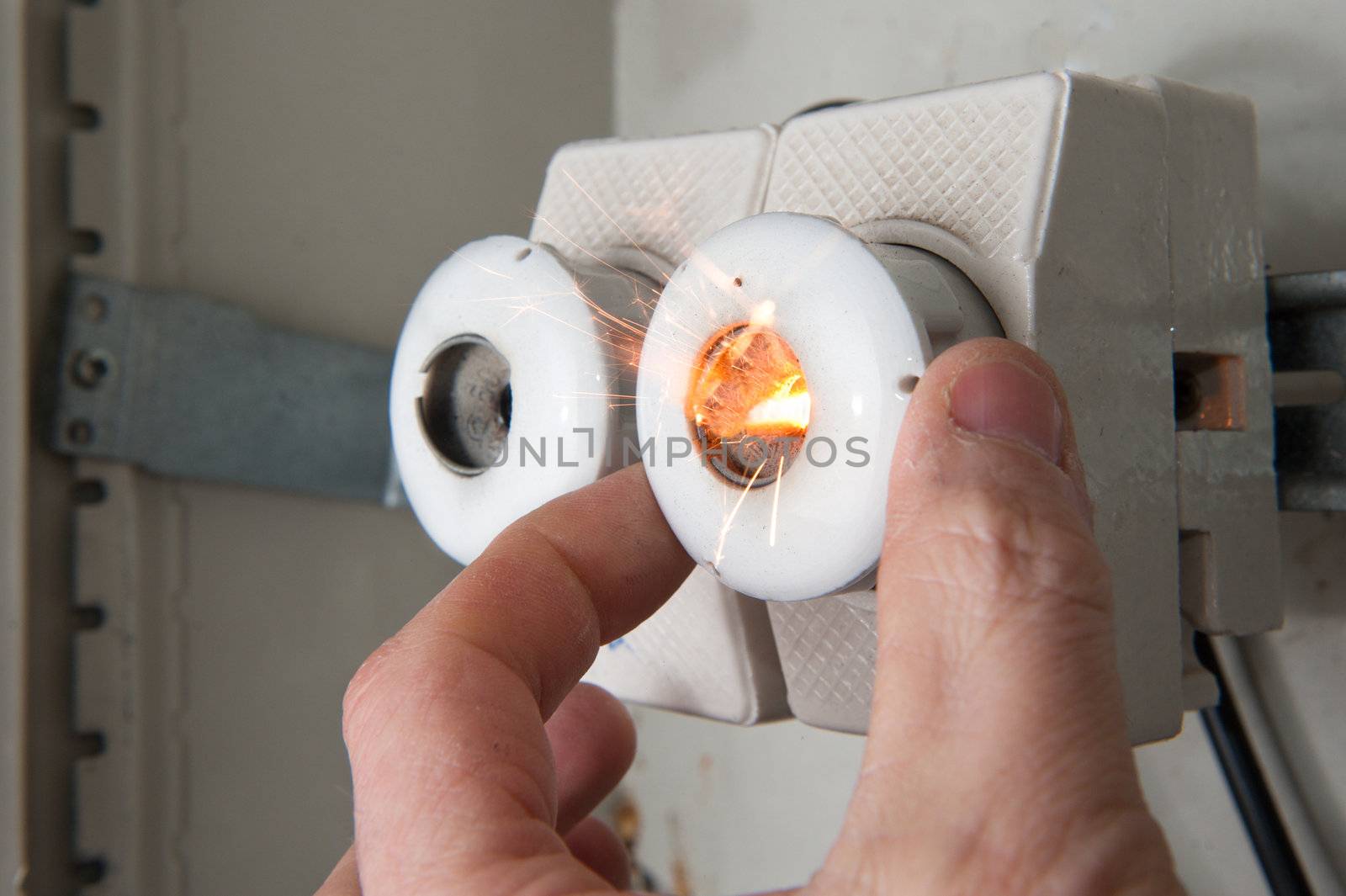 Person mounting new fuse on short circuited line