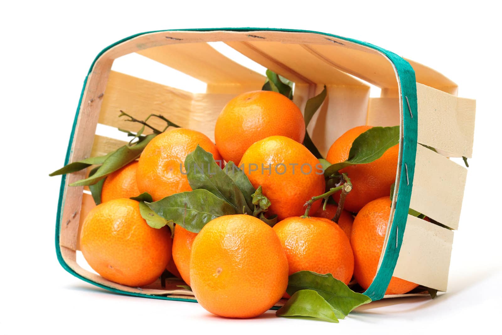 fresh tangerines in a basket on white background