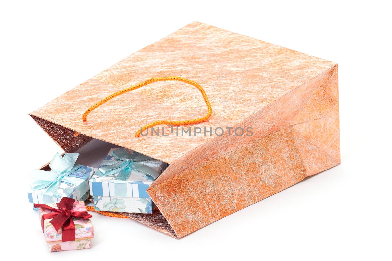 photo of golden Shopping Bag with gifts on white background