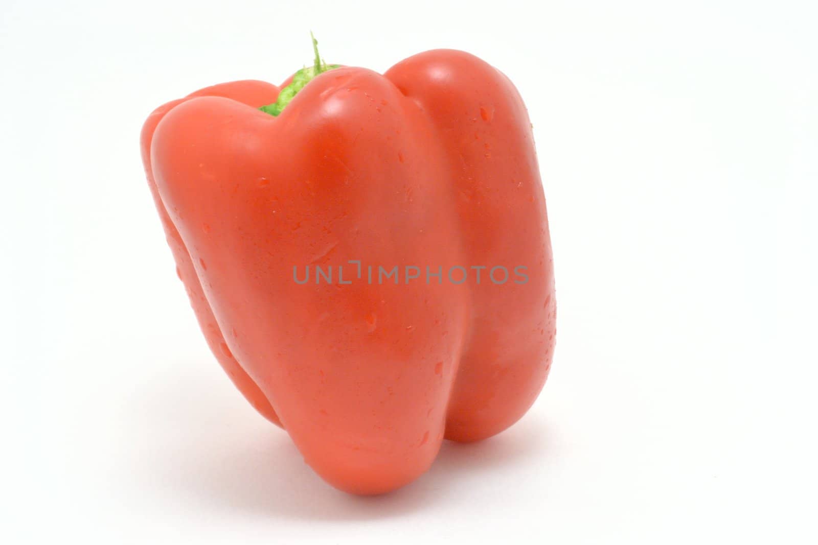Fresh red pepper over the white background