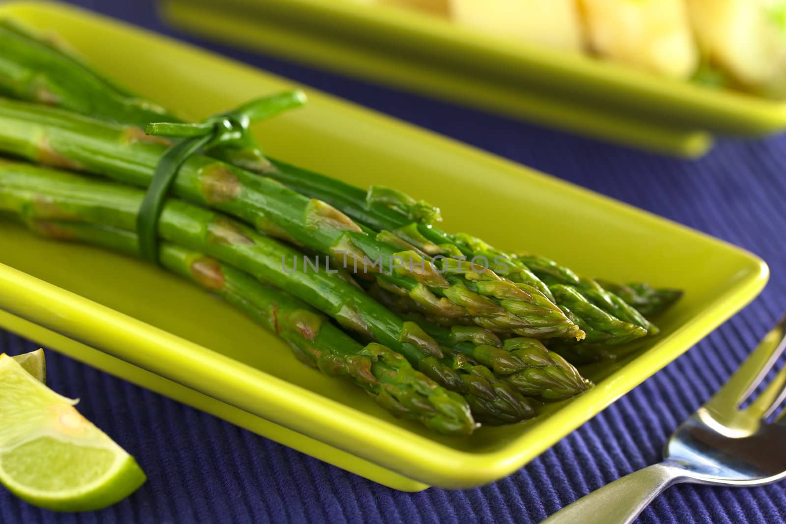 Cooked green asparagus (Selective Focus, Focus on the asparagus tip on the top)