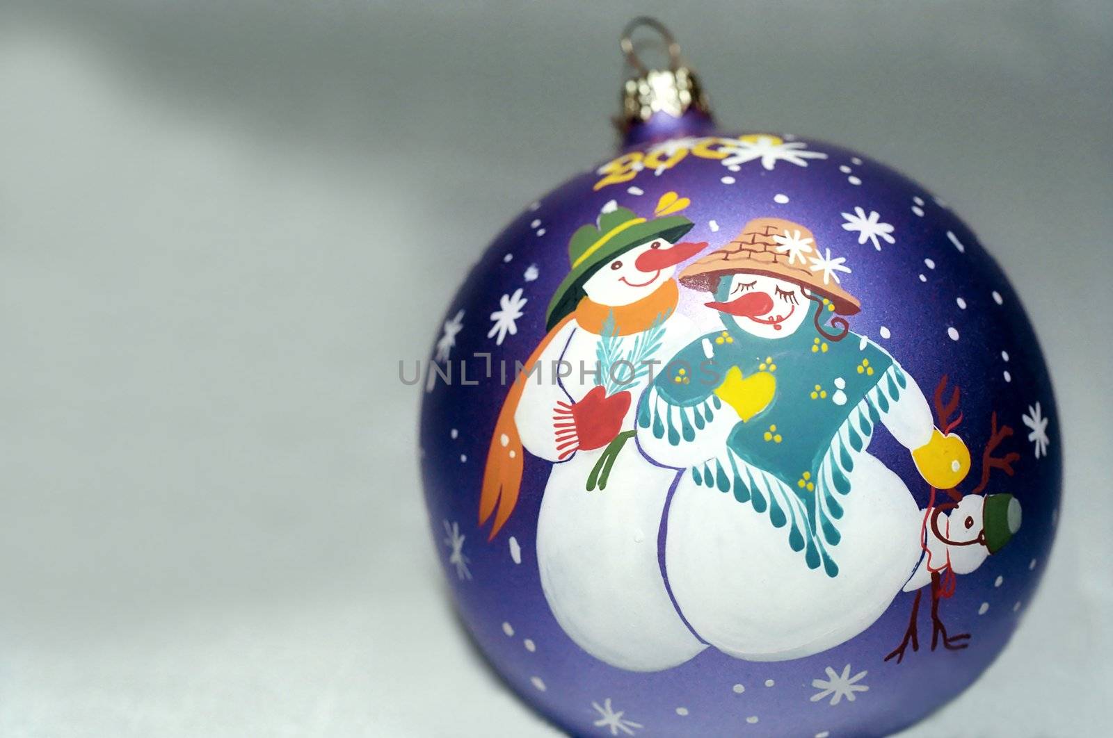 New Year decoration sphere with drawing of snowmans