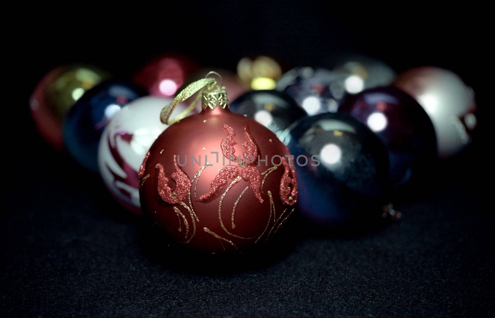 Red glass sphere with floral pattern on Christmas decoration background