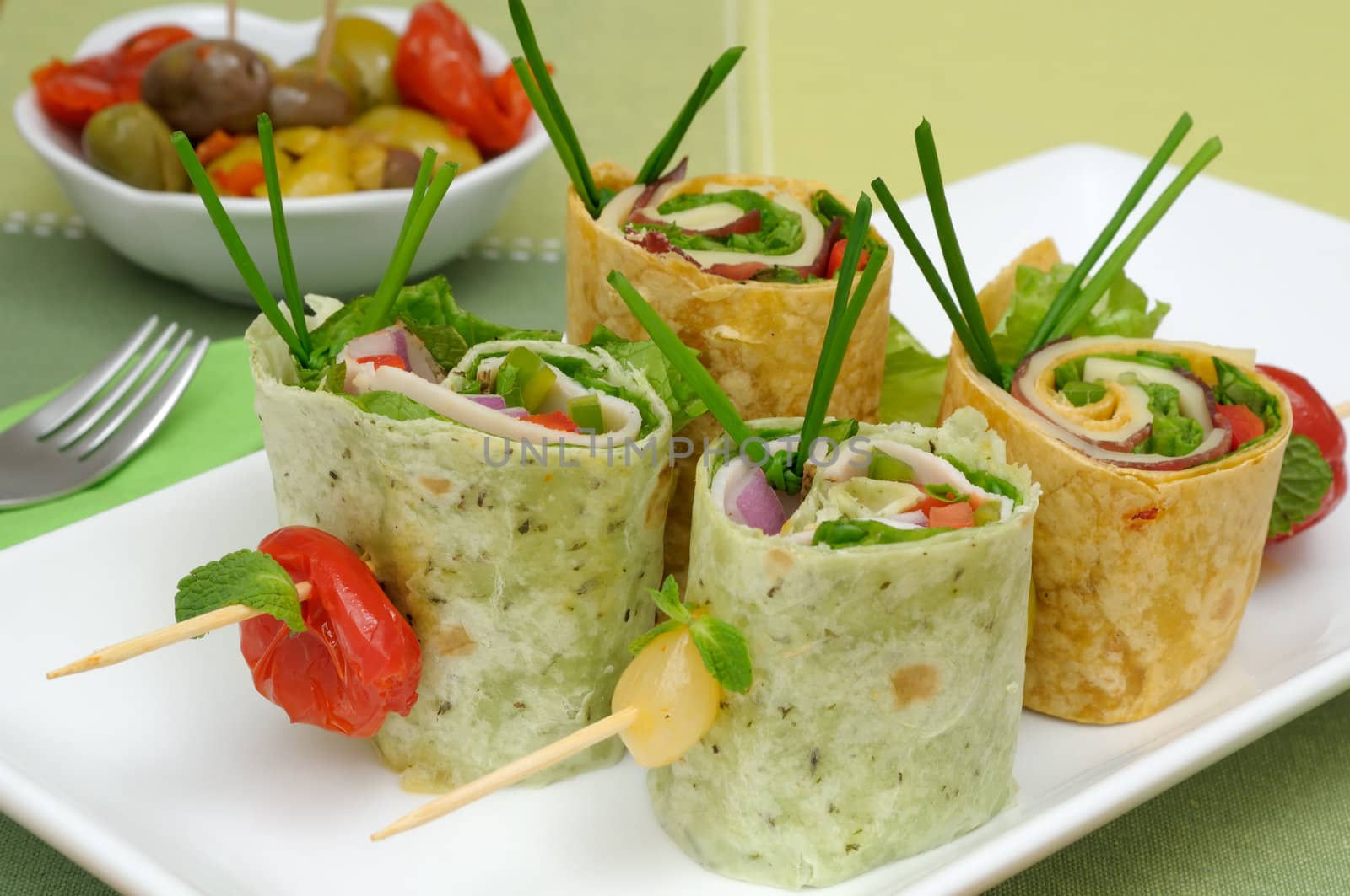 Brochettes made of colored tortillas, cheese, chicken slices and vegetable