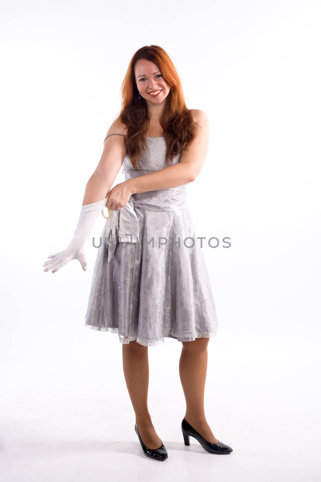 Young girl with white gloves standing on white background
