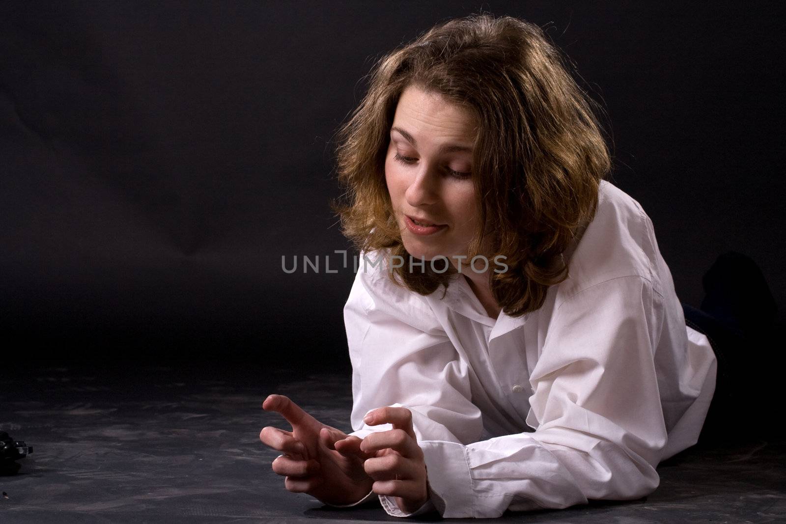 smiling lying woman on black background
