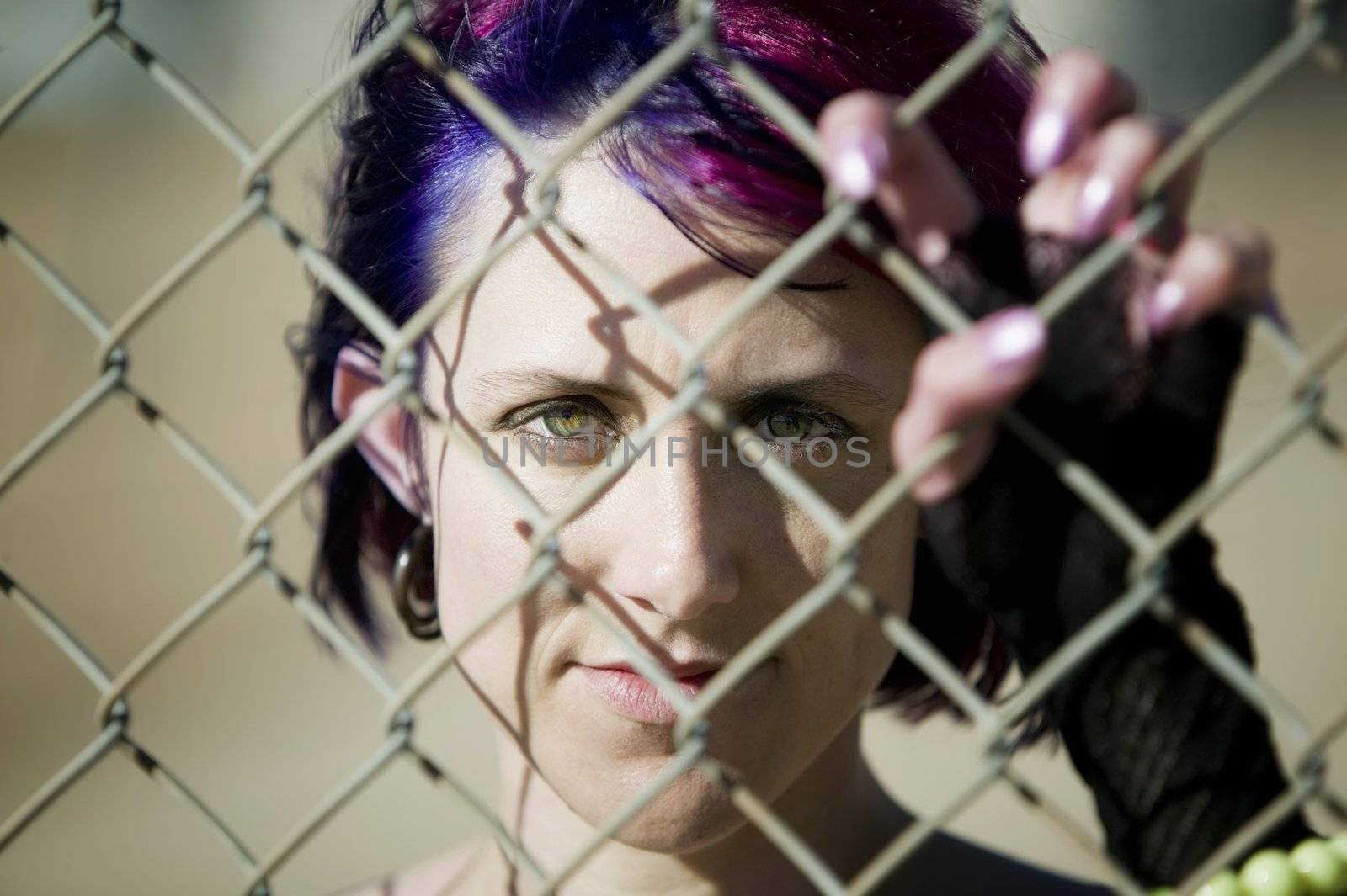 Woman behind chain link by Creatista