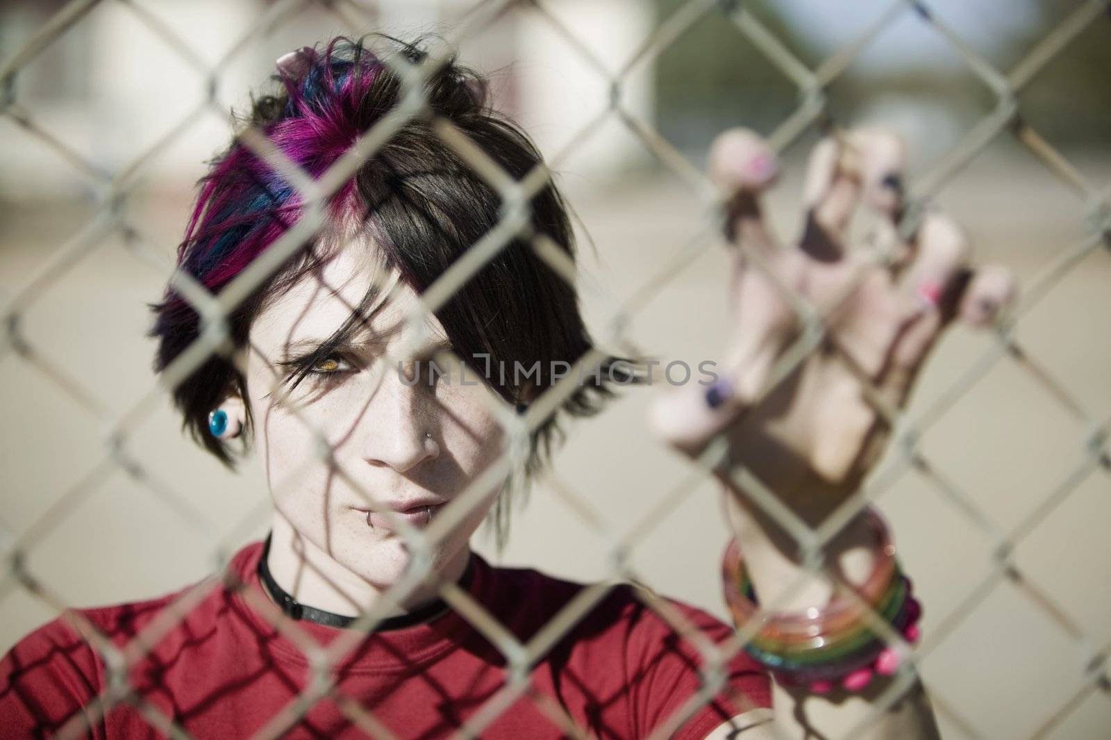 Young Punk Girl Being Shadowed By Chain Link