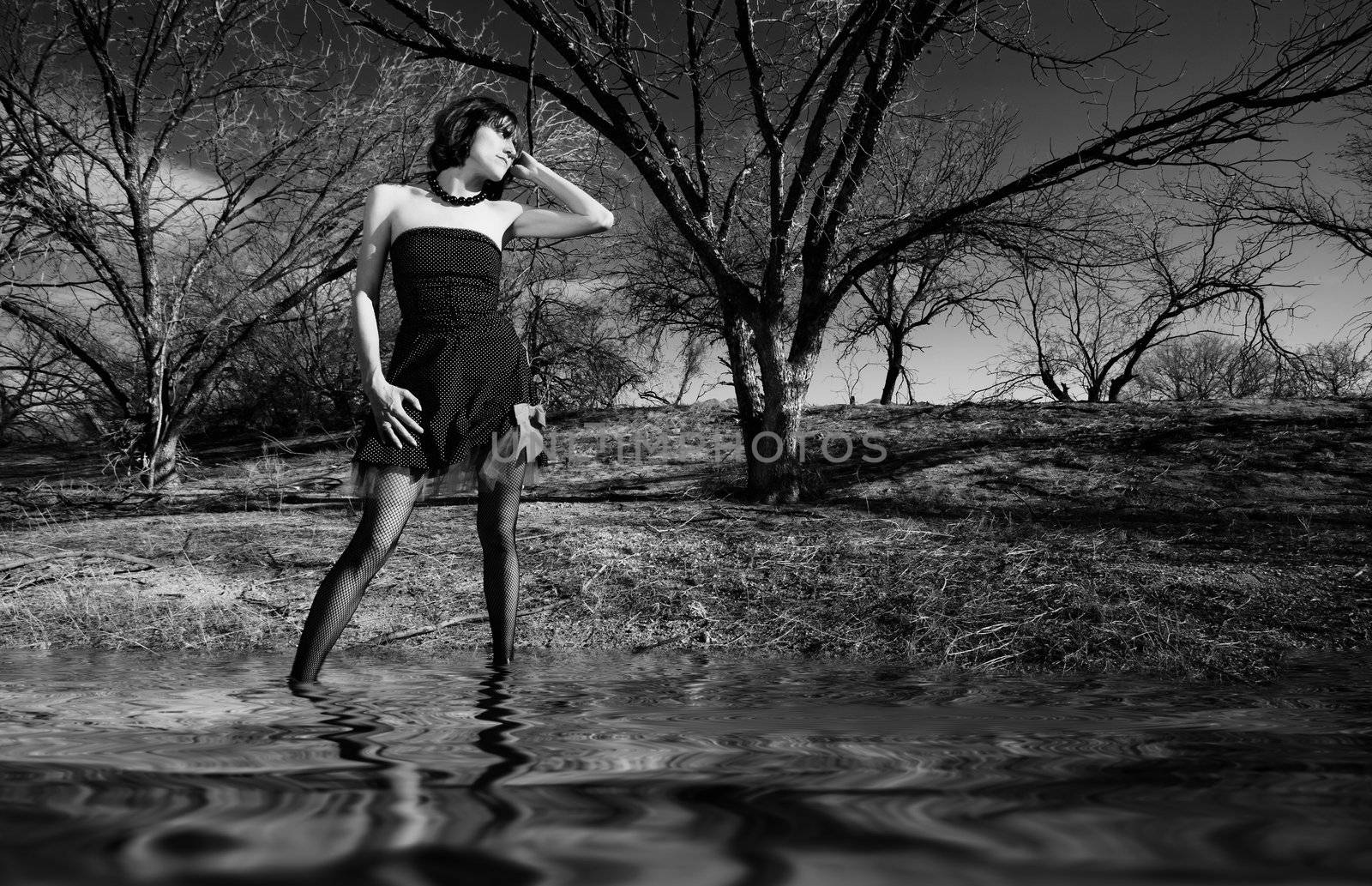 Punk fashion model in front of dead trees