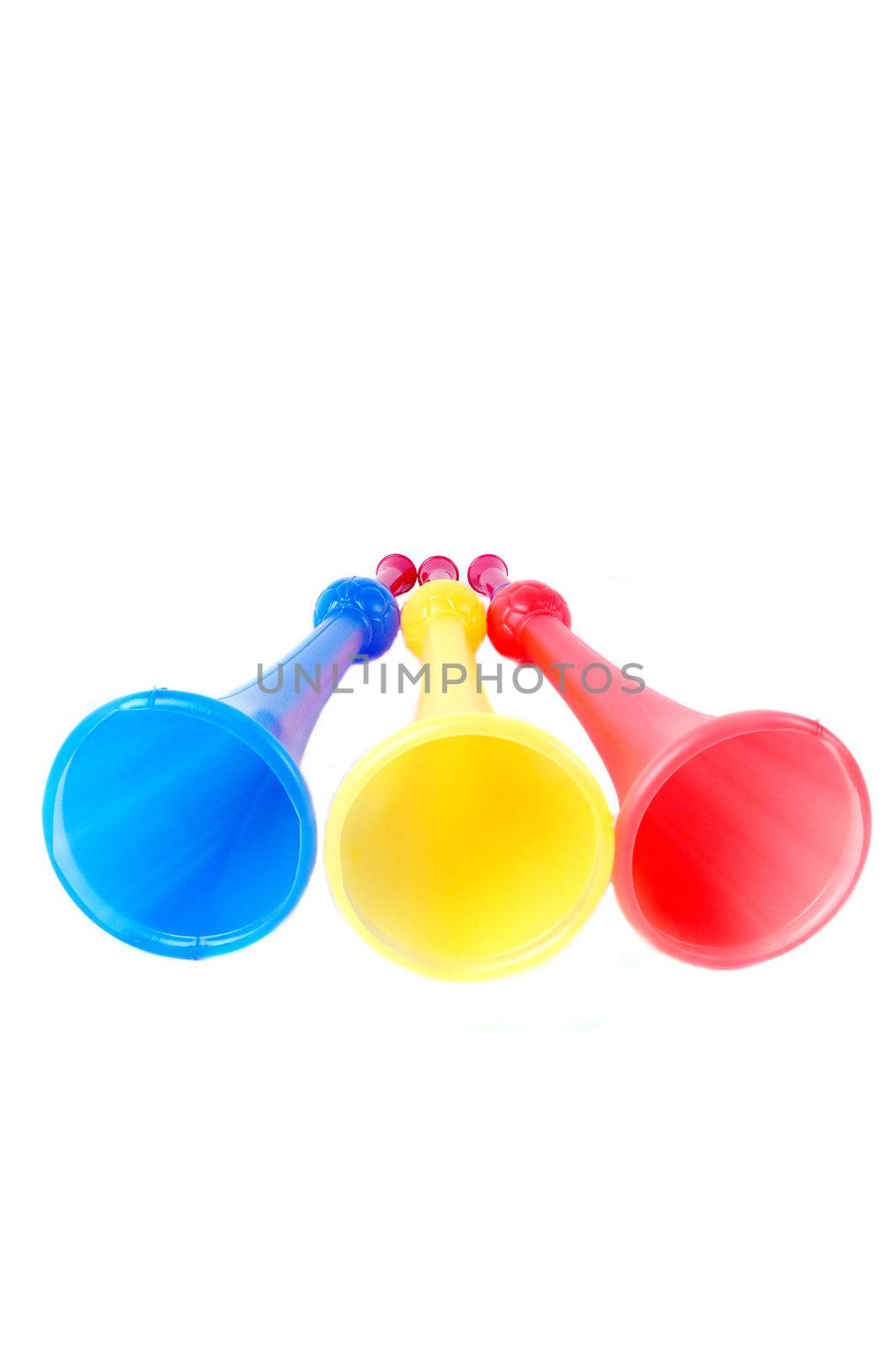 three colorful plastic terumpet isolated on white background