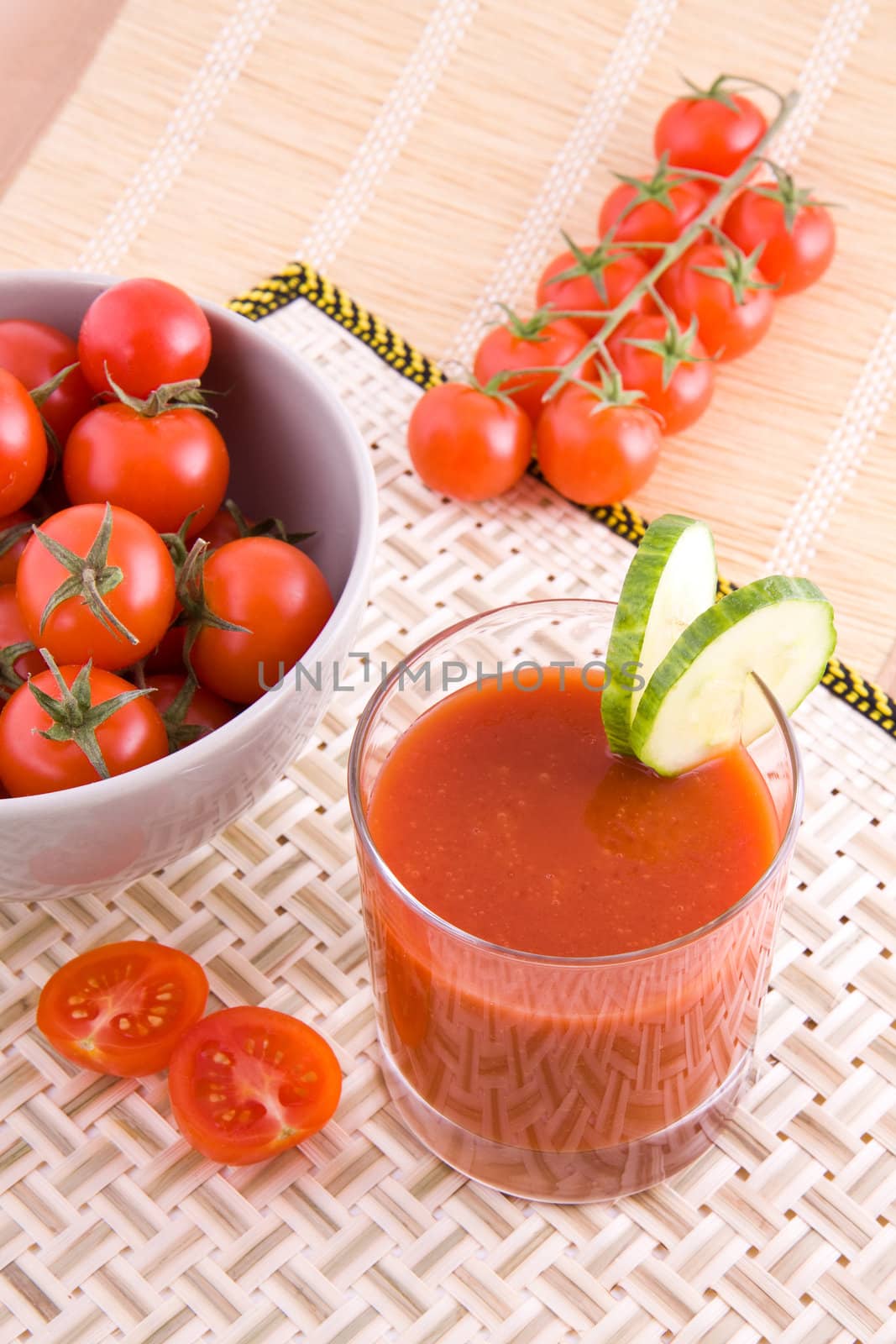 Fresh tomato juice with slices of cucumber, small vegetables