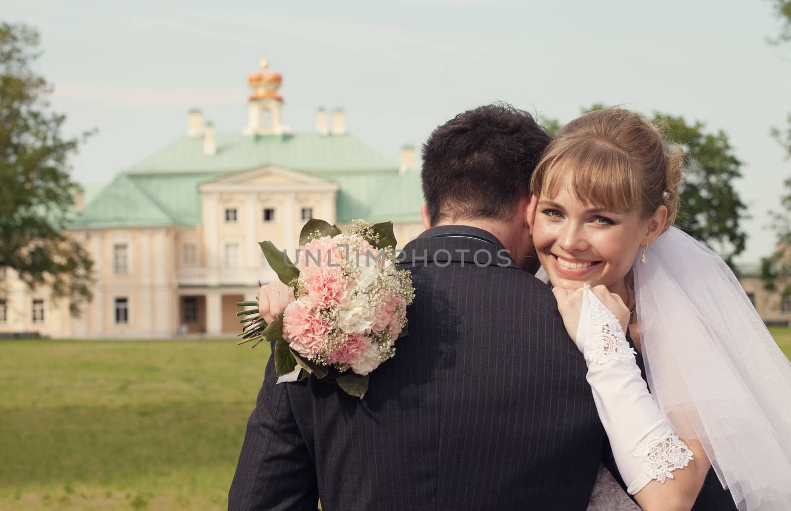  bride put her face on a shoulder of the groom