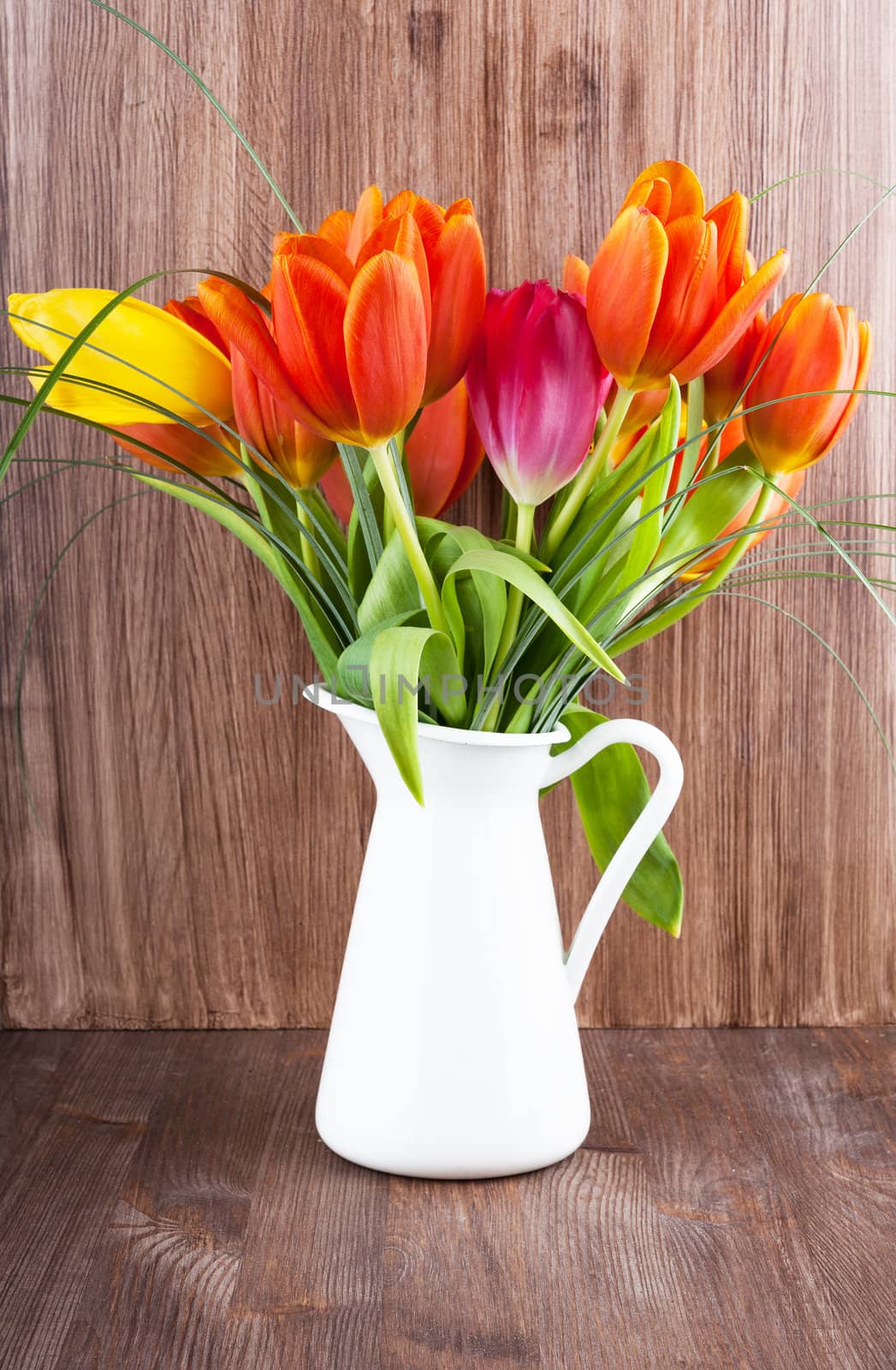 Bouquet of colorful tulips on dark wooden background