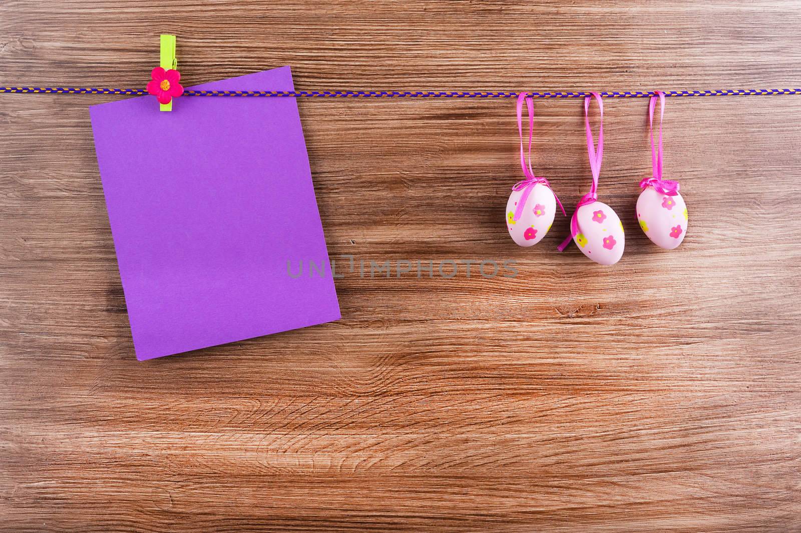 Card and eggs on a wooden surface background