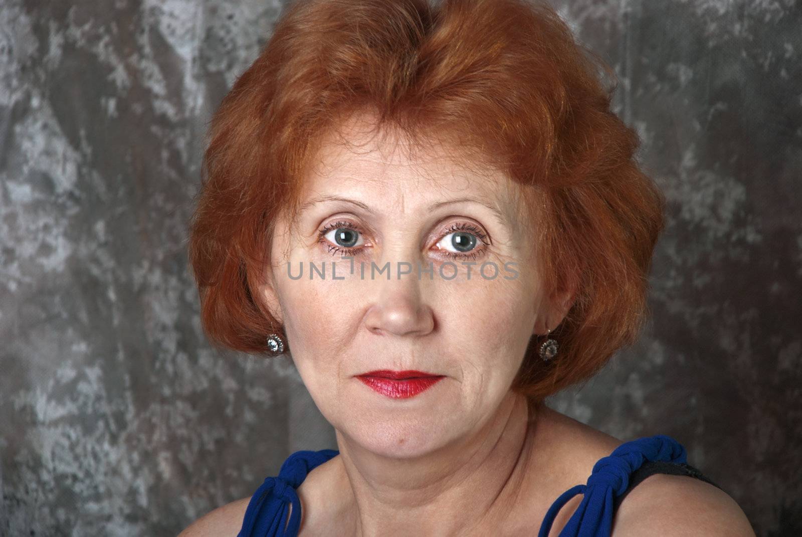 Closeup portrait beautiful adult woman on the abstract background.