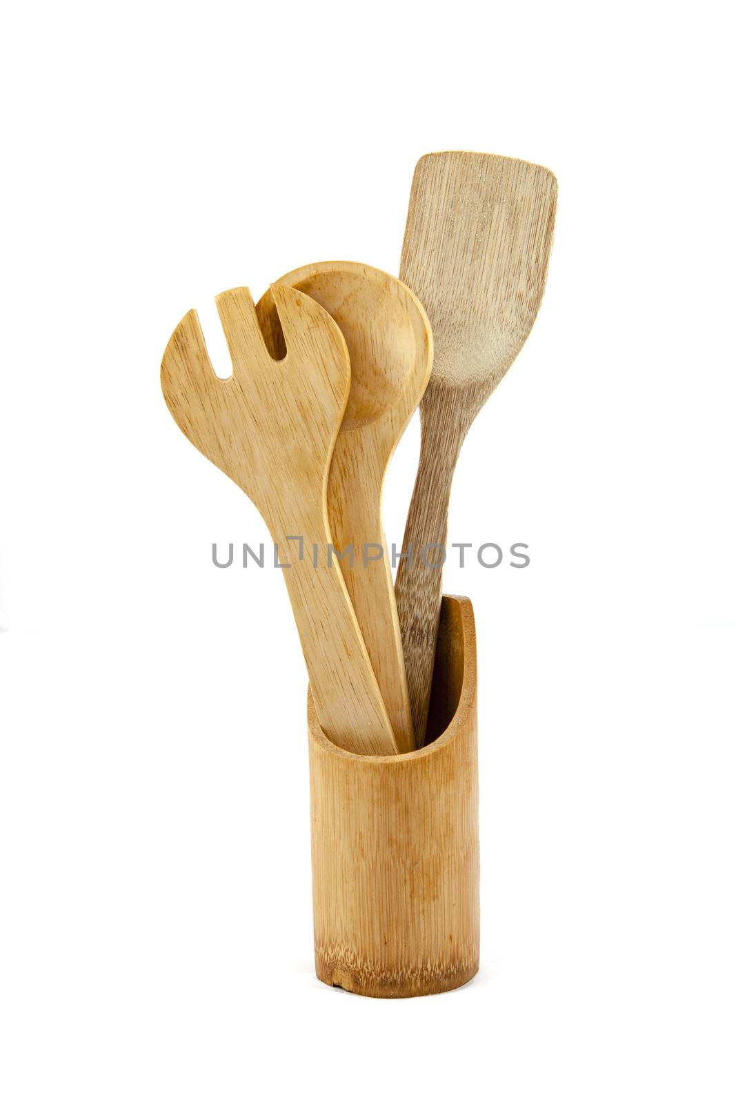 Wooden kitchen utensils over white backdrop