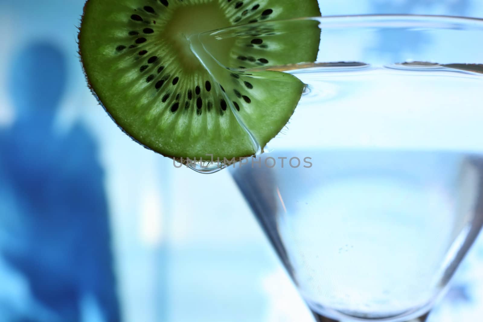 Glass with a plate kiwi on a dark blue background