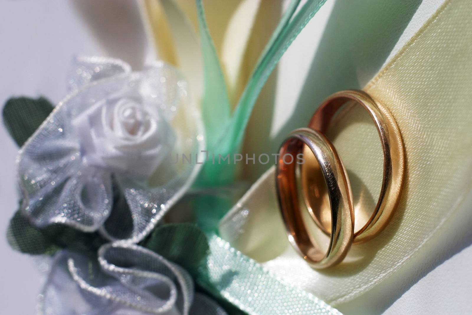 Wedding rings on a blue satiny fabric