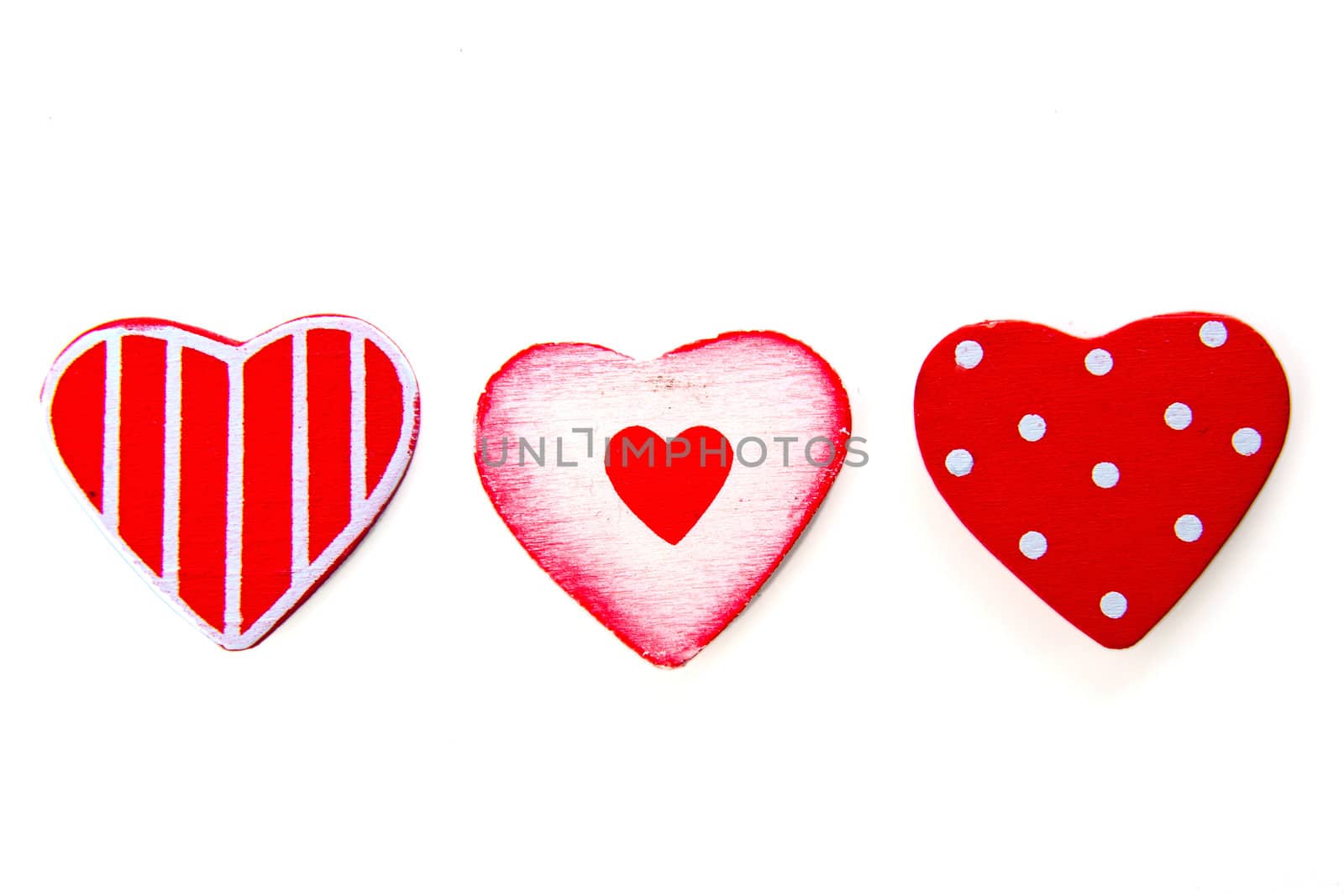 three (wooden) hearts in a row