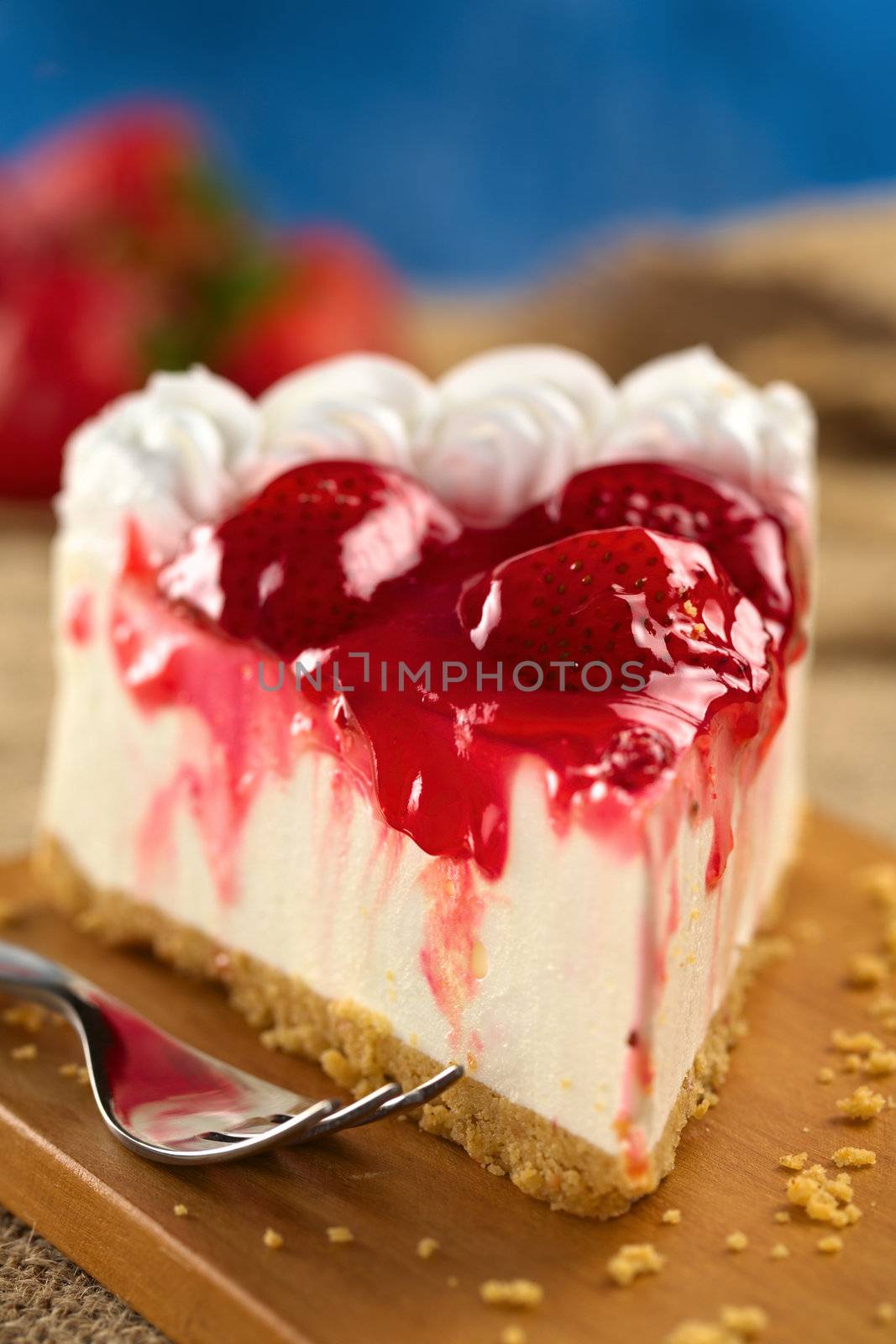 Fresh strawberry cheesecake (Selective Focus, Focus on the glazing running down on the left and the front of the first strawberry on the cake)