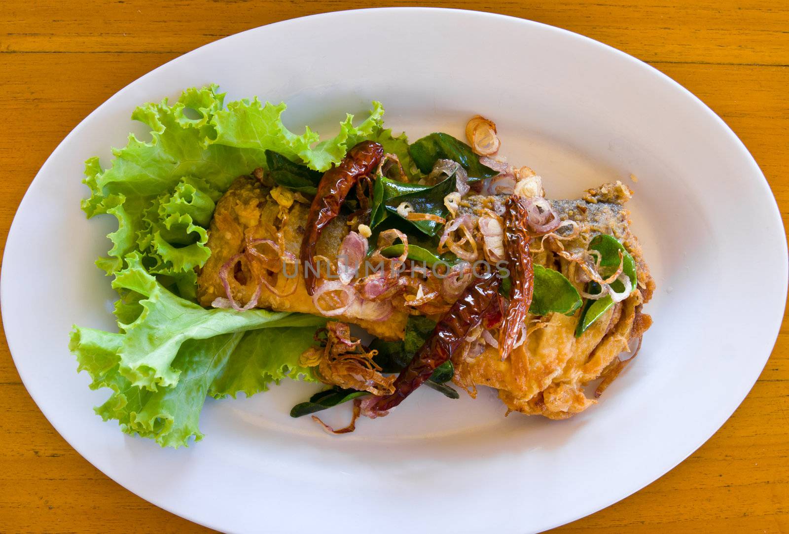 Fried fish with fresh herbs and spicy