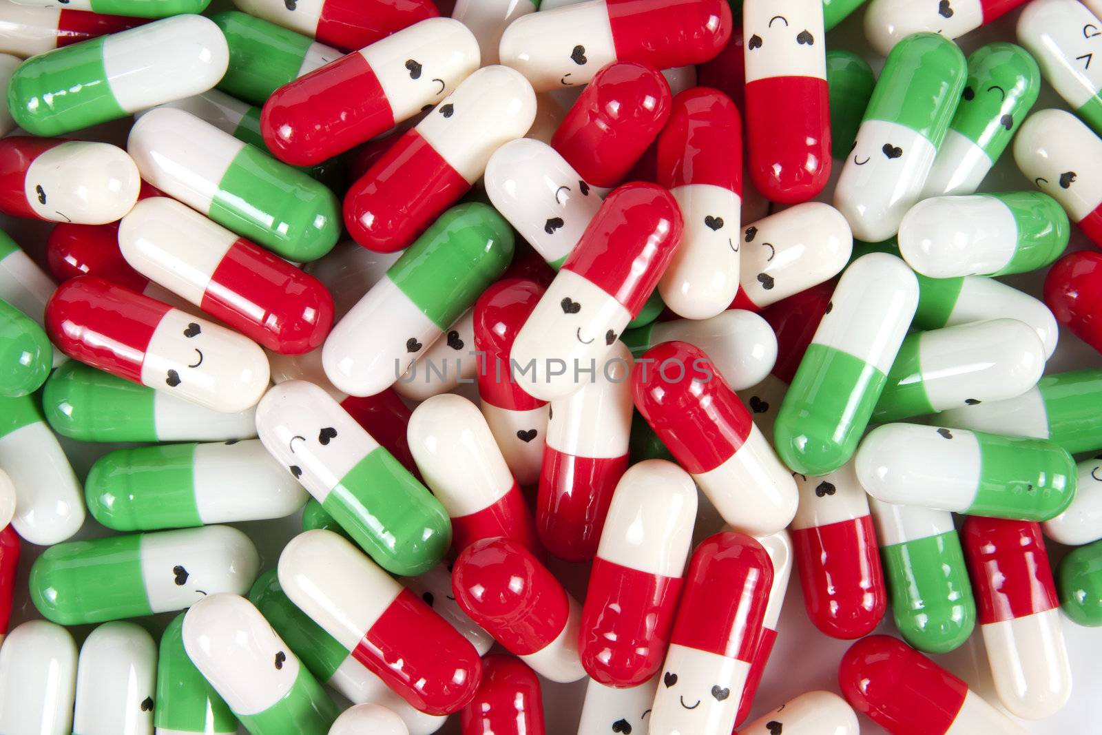 Green red and white happy emotion capsules on white background 
