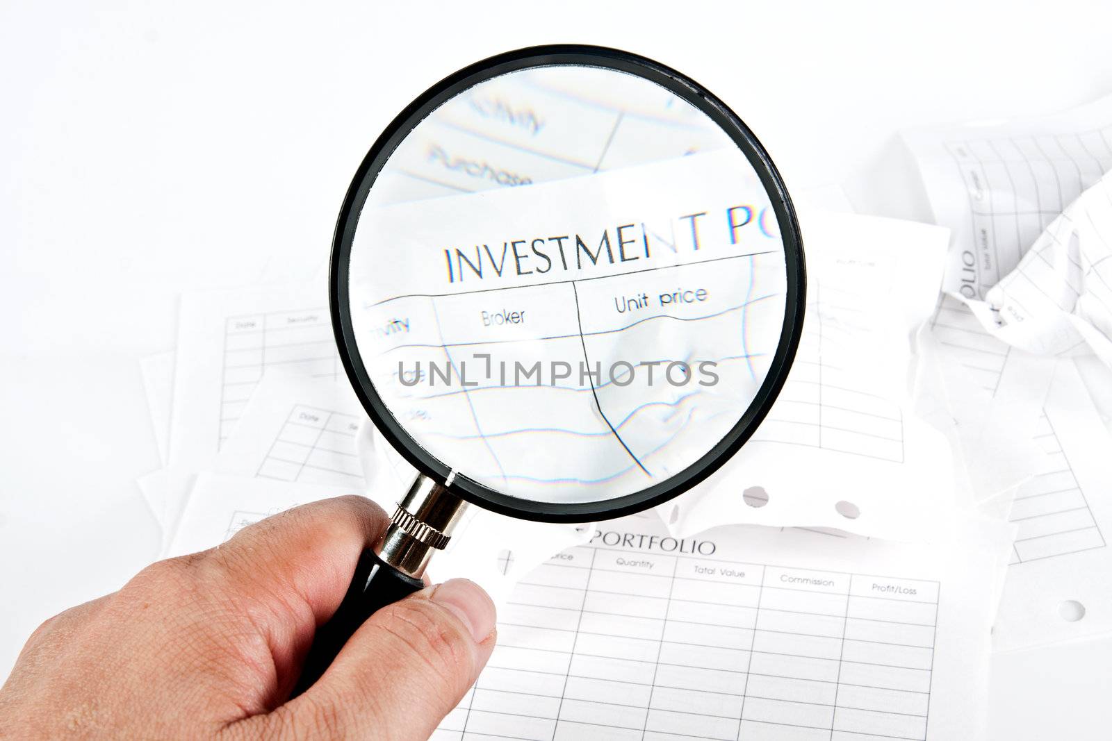 Close up stack of investment Spreadsheets and Magnifying Glass